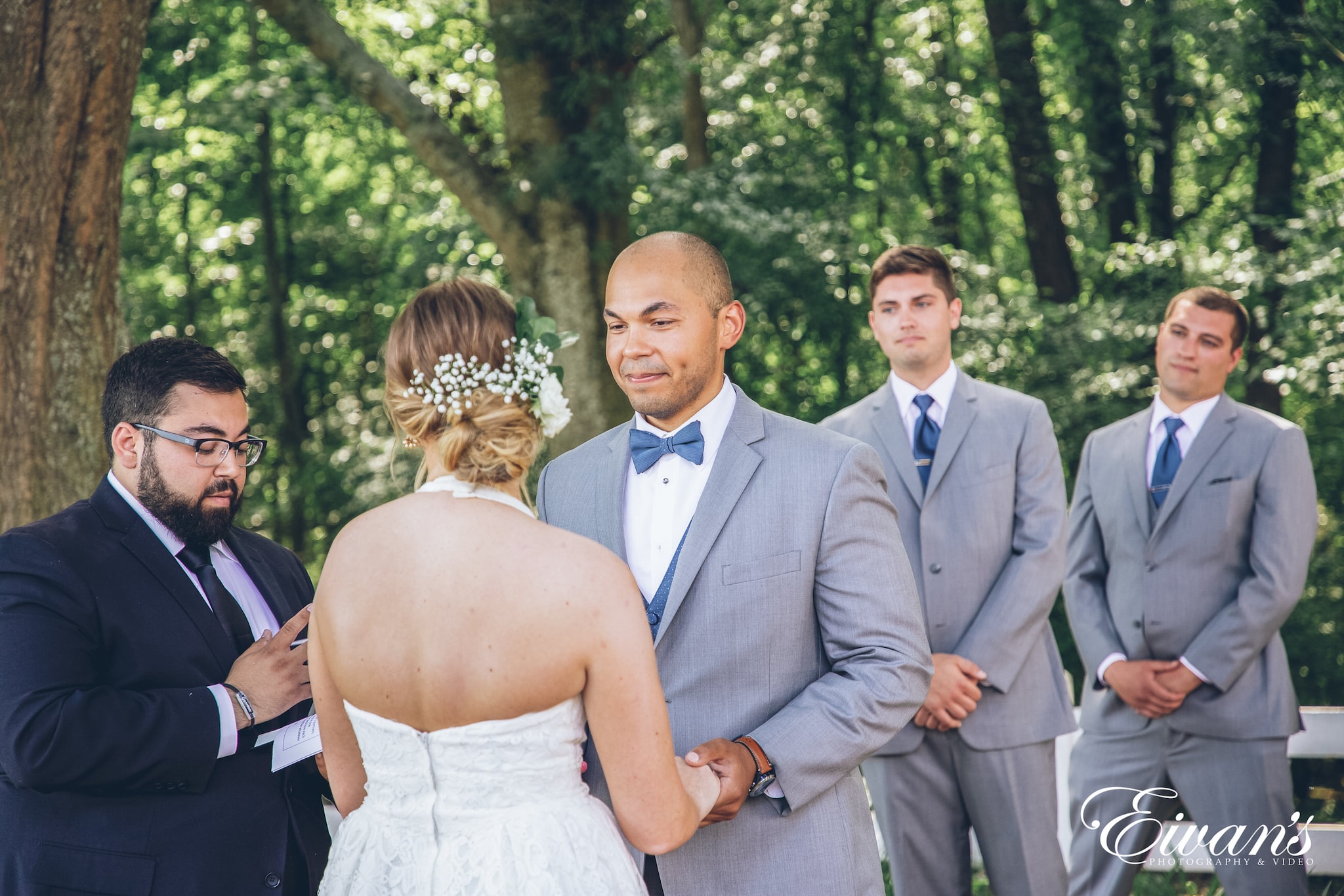 man and woman holding hands at the alter