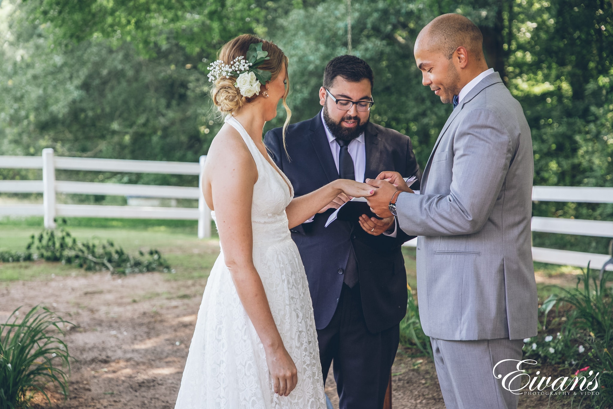 man putting ring on woman at the alter