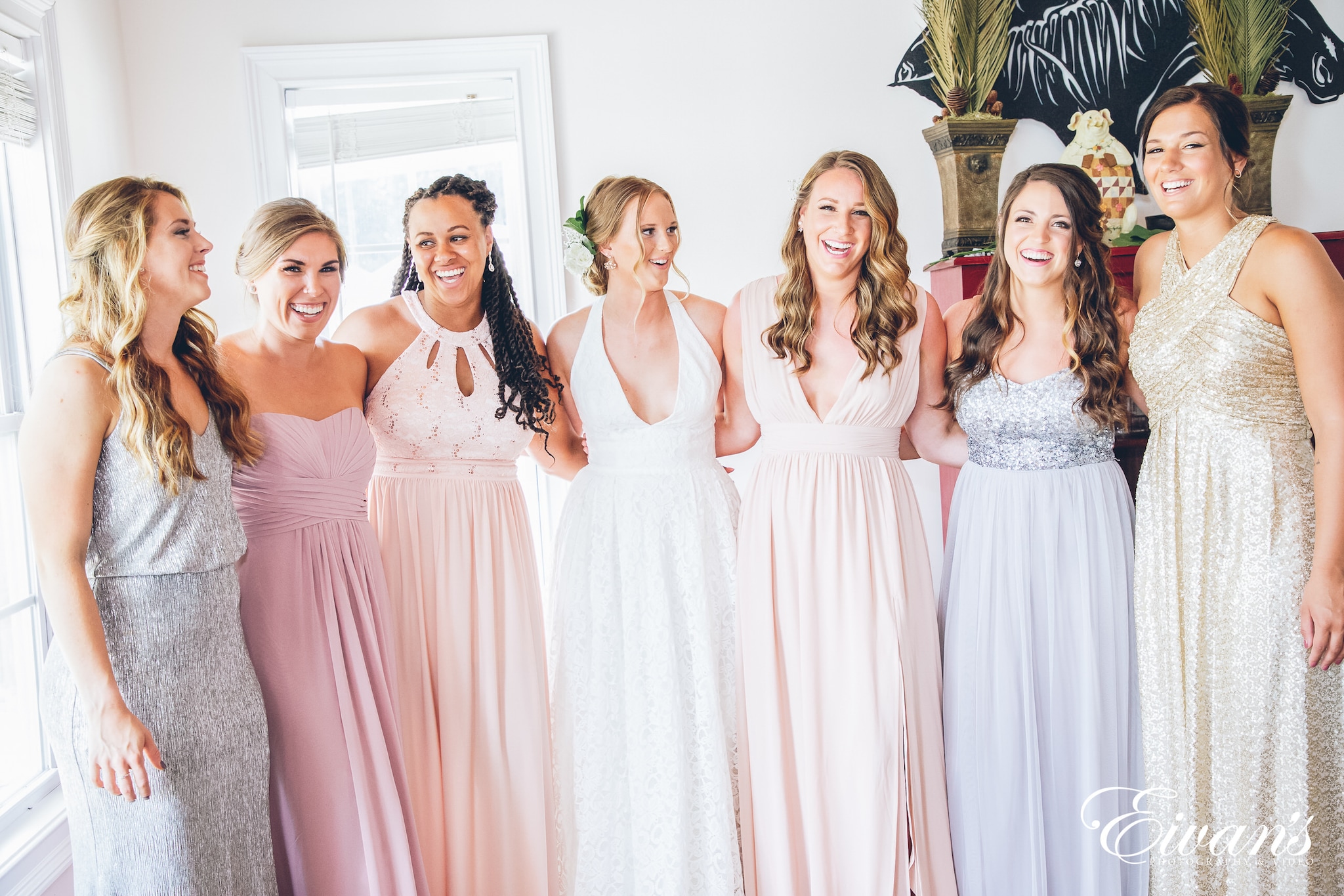 woman in a white dress with her bridesmaids