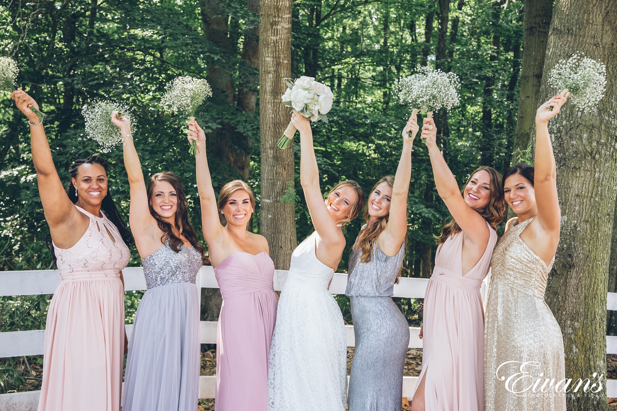 woman in a white dress with her bridesmaids