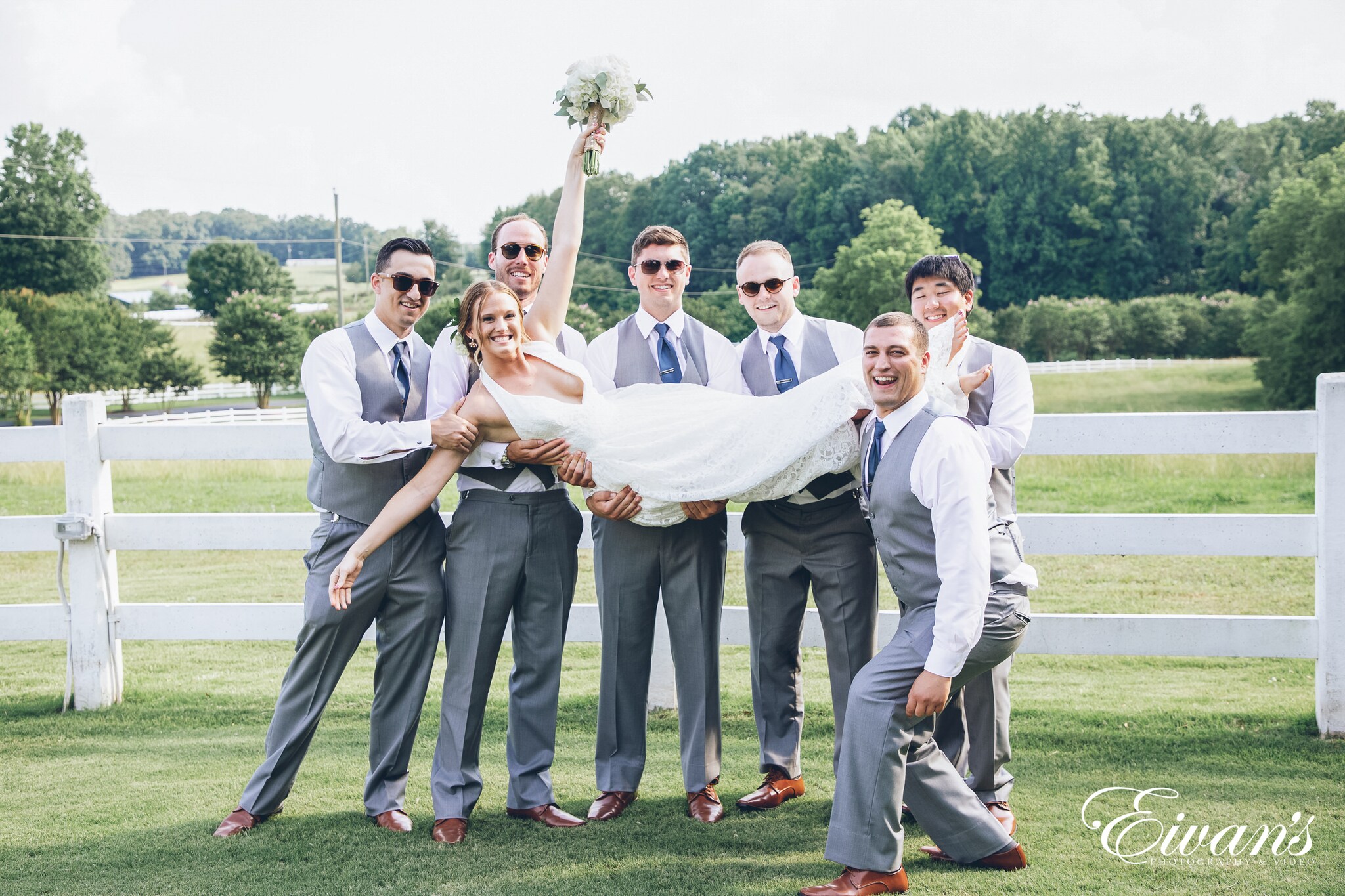 groomsmen holding the bride