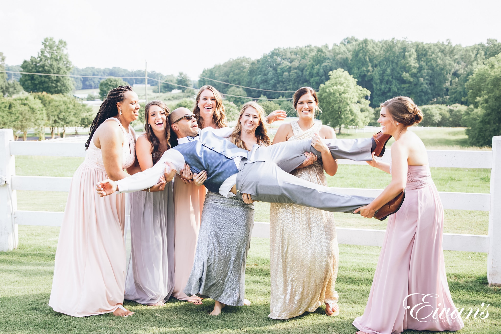 bridesmaids holding the groom