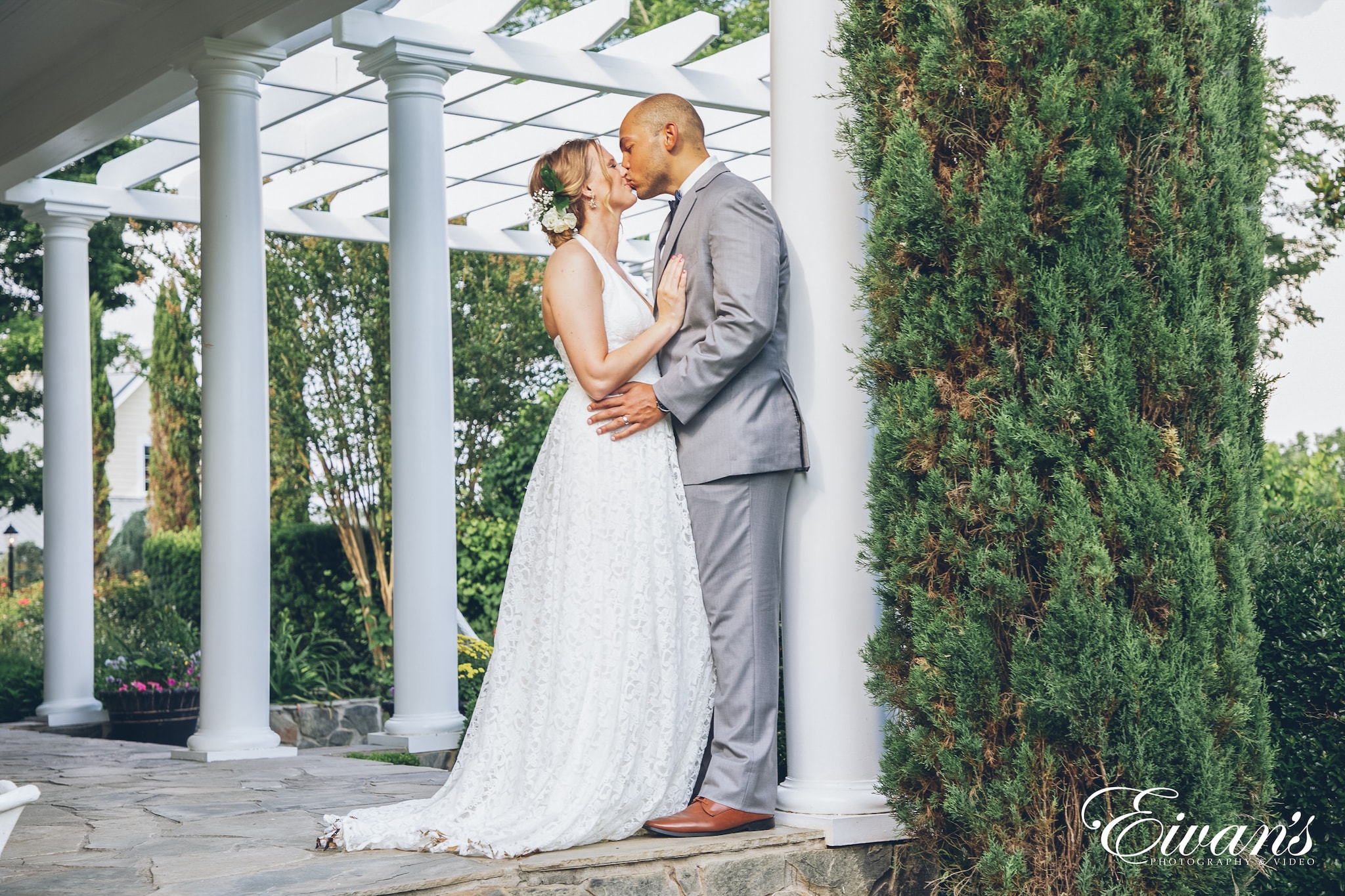 man and woman in white dress kissing