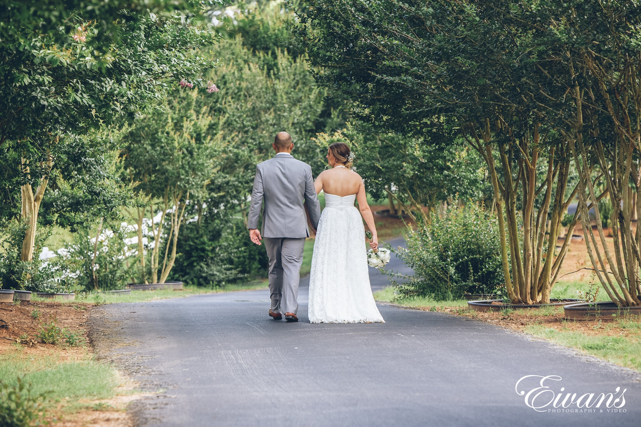 bride and groom walking on street during the day