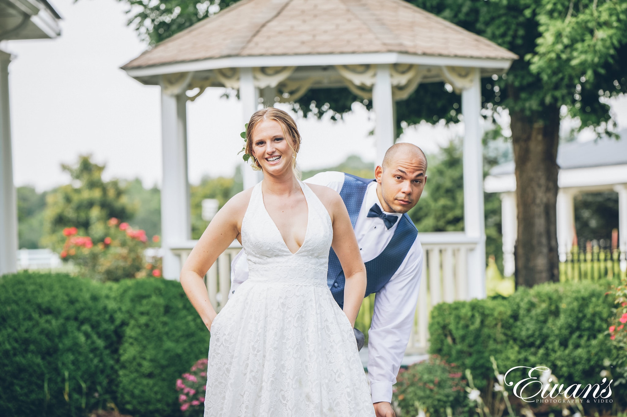 bride posed with the groom behind her