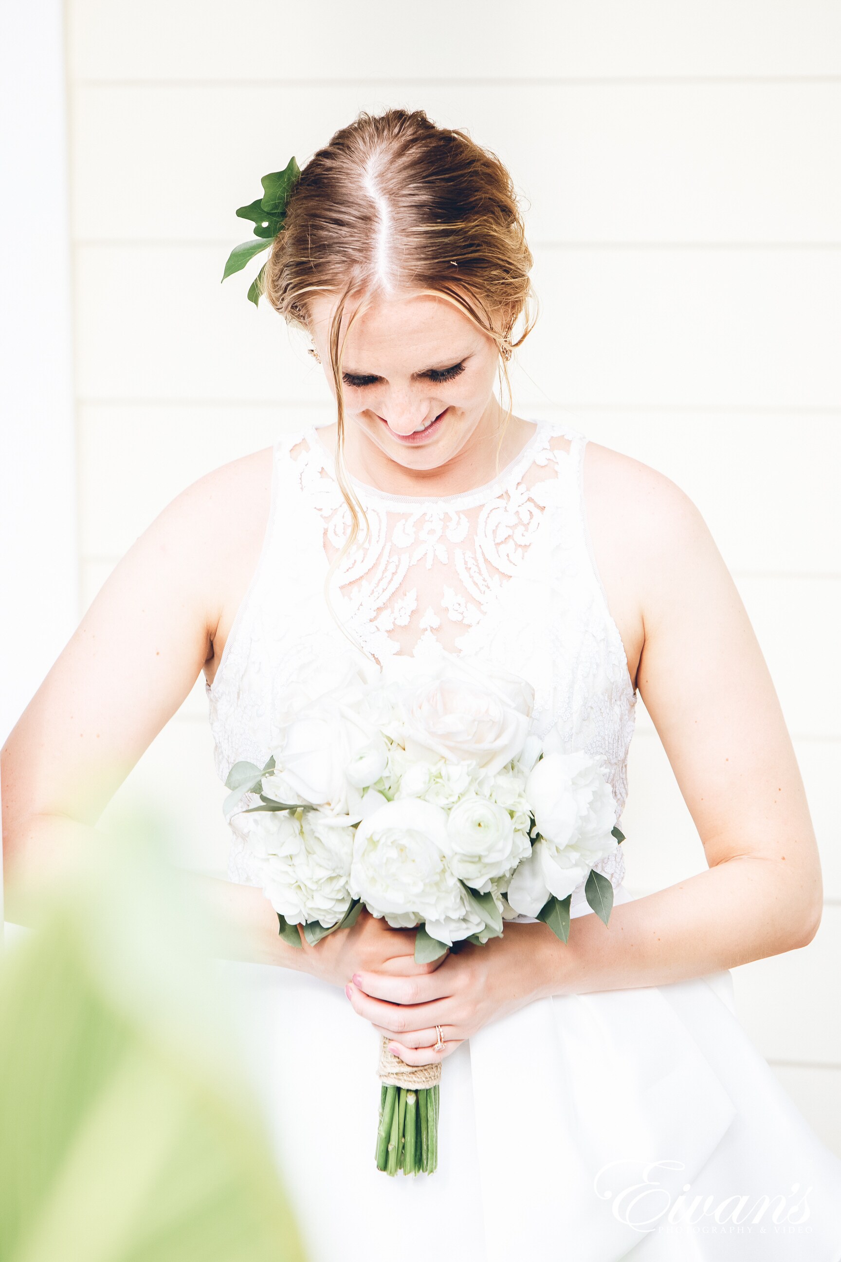 woman wearing a white dress holding a bouquet of flowers