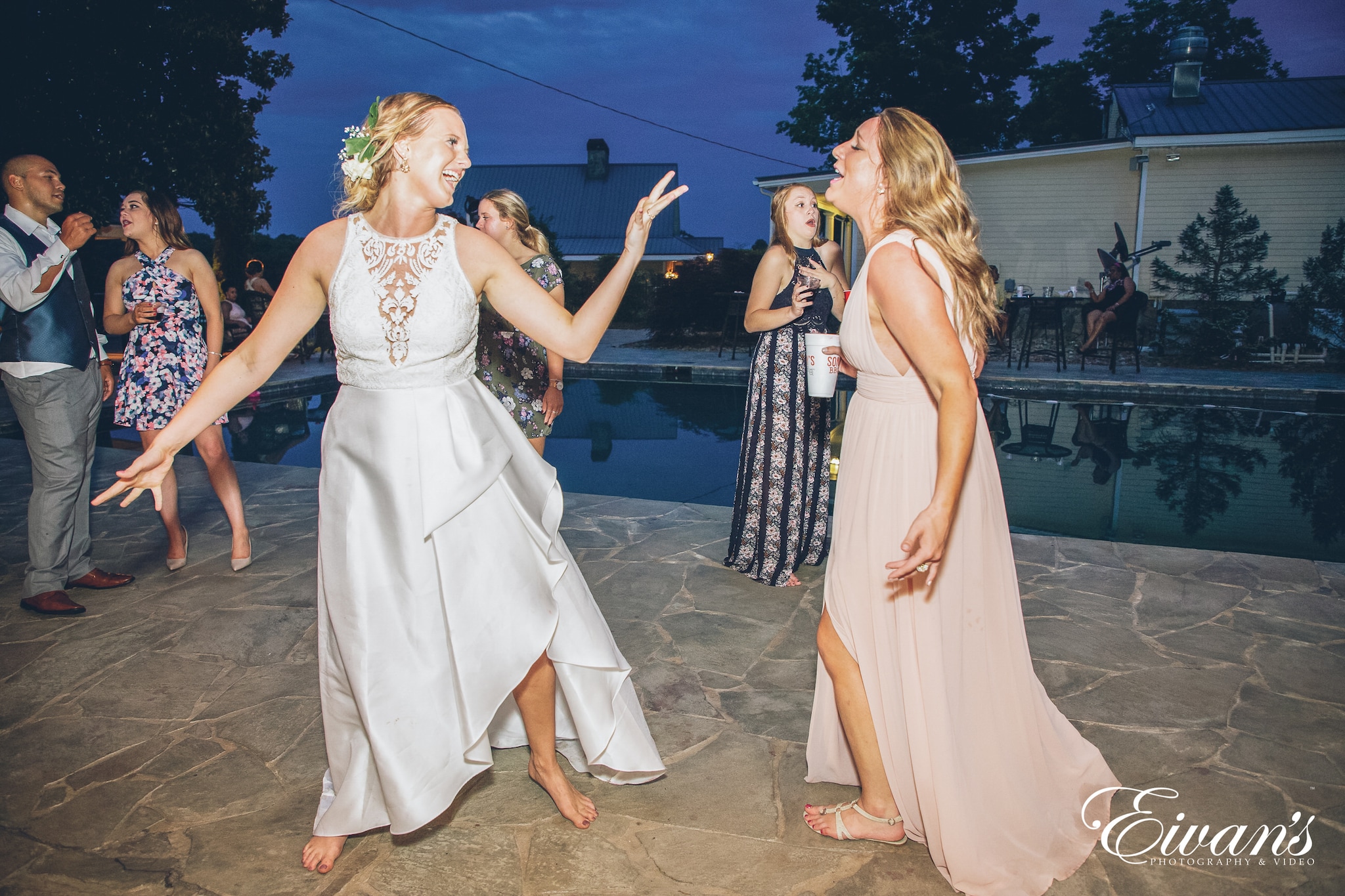 woman in a white dress and woman in a pink dress dancing