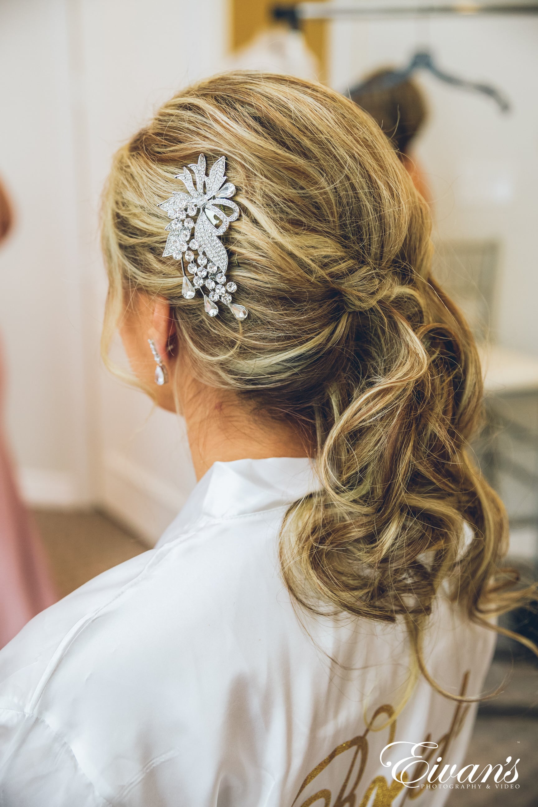 woman in white shirt with white and black floral hair tie