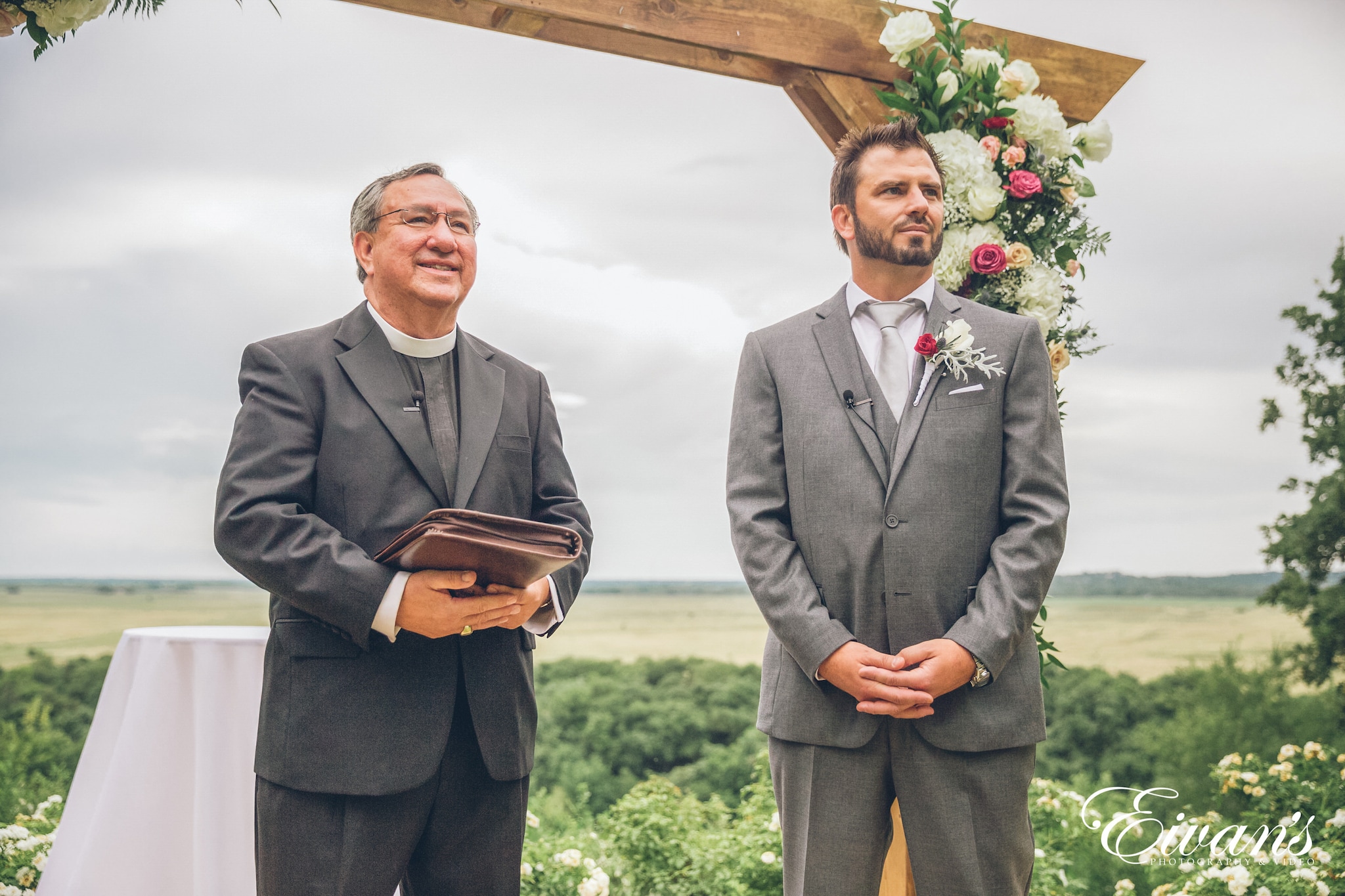 man in gray suit jacket holding book