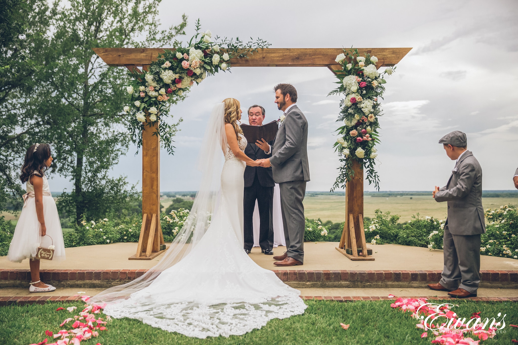 bride and groom standing on green grass field during daytime