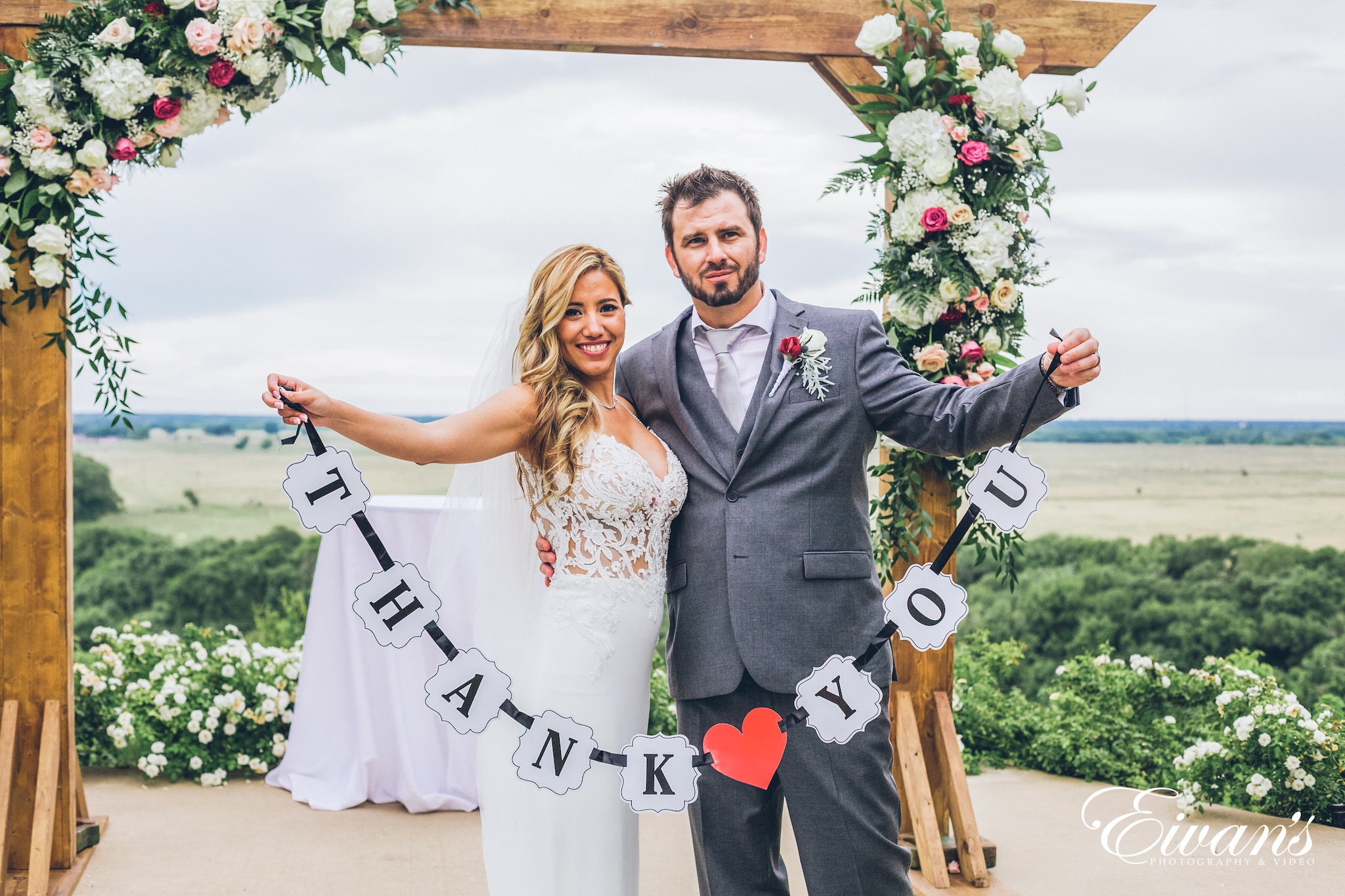 man in black suit jacket holding woman in white wedding dress