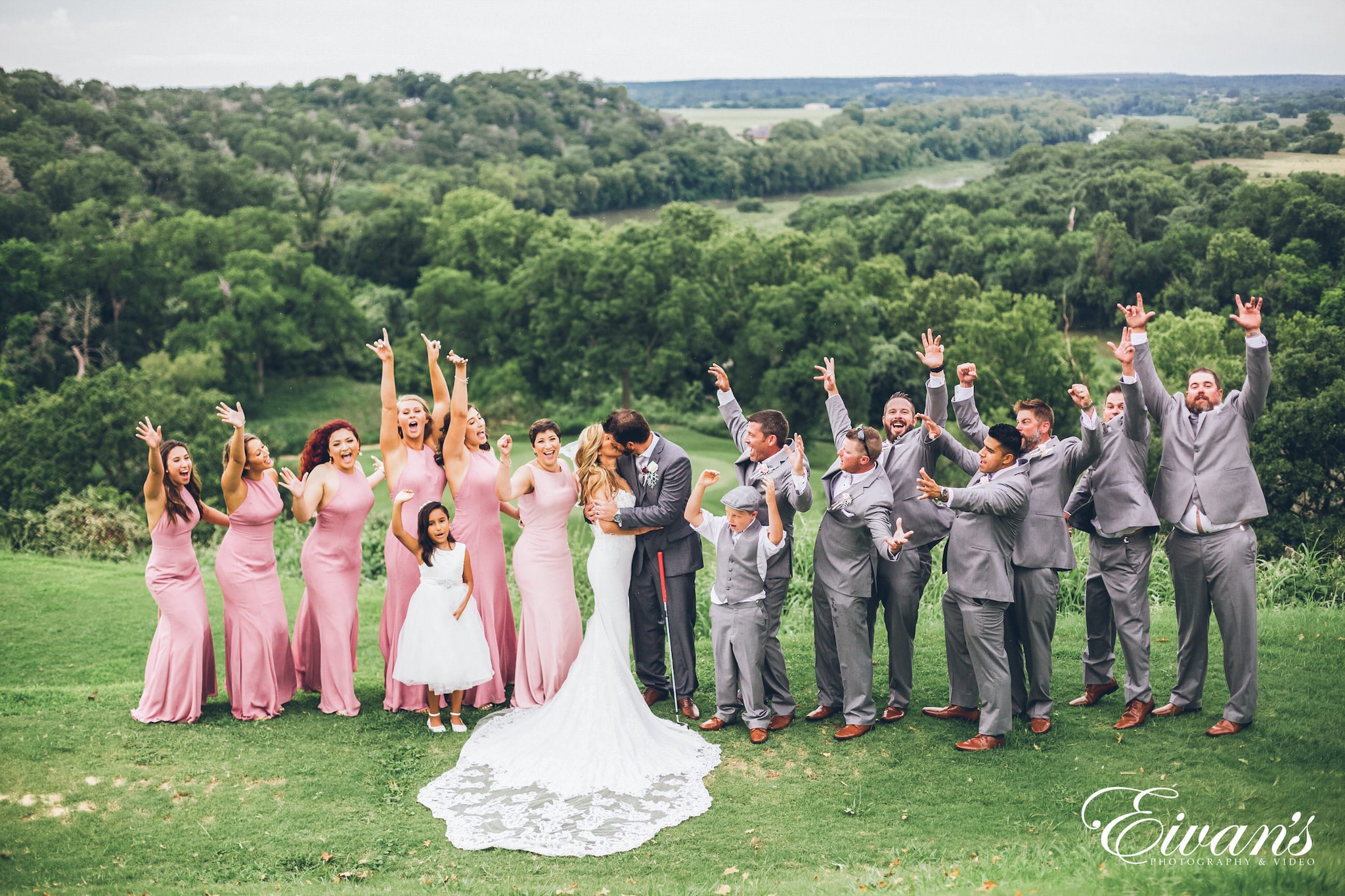 group of people in wedding dress standing on green grass field during daytime