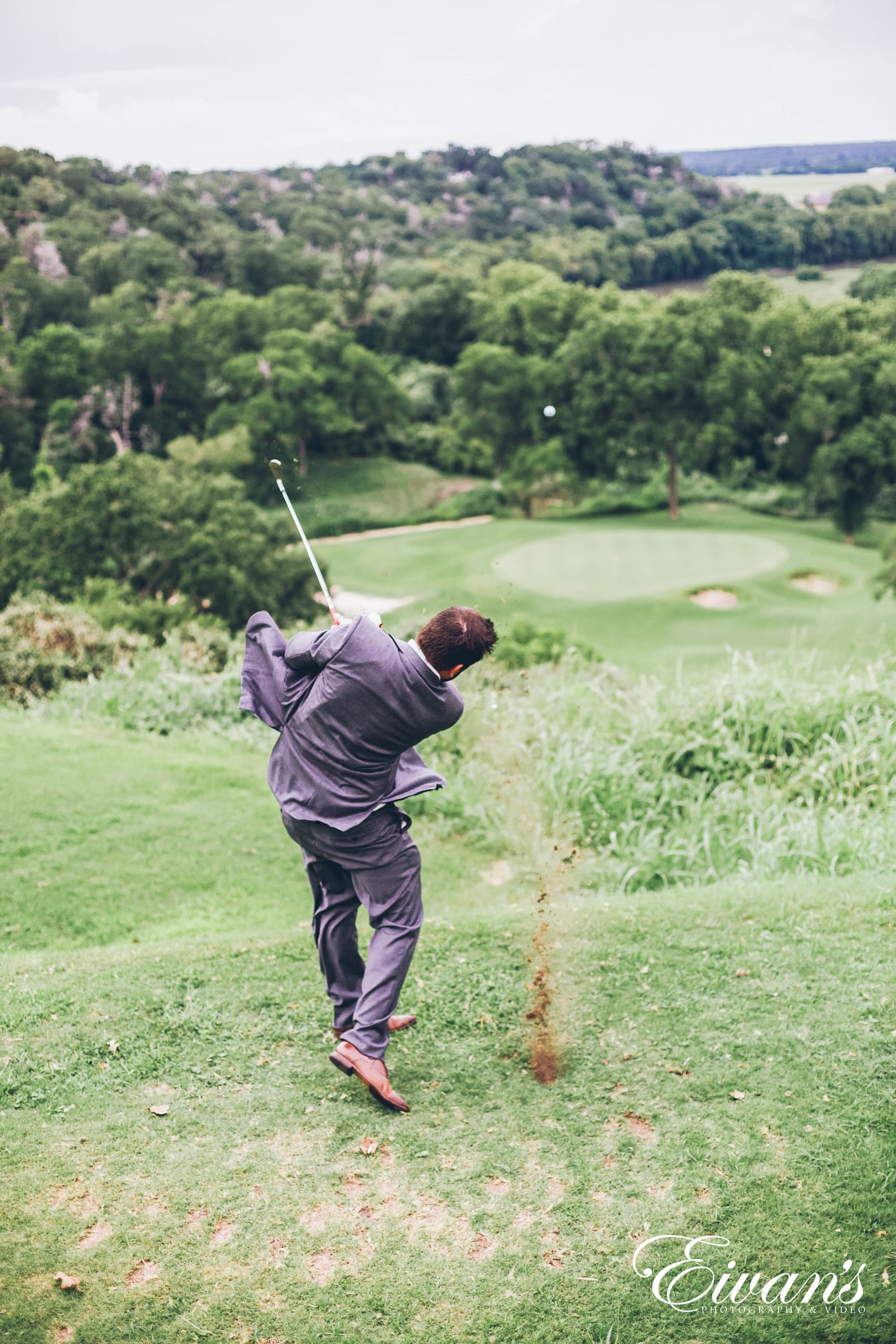 man in gray jacket and green pants playing golf during daytime