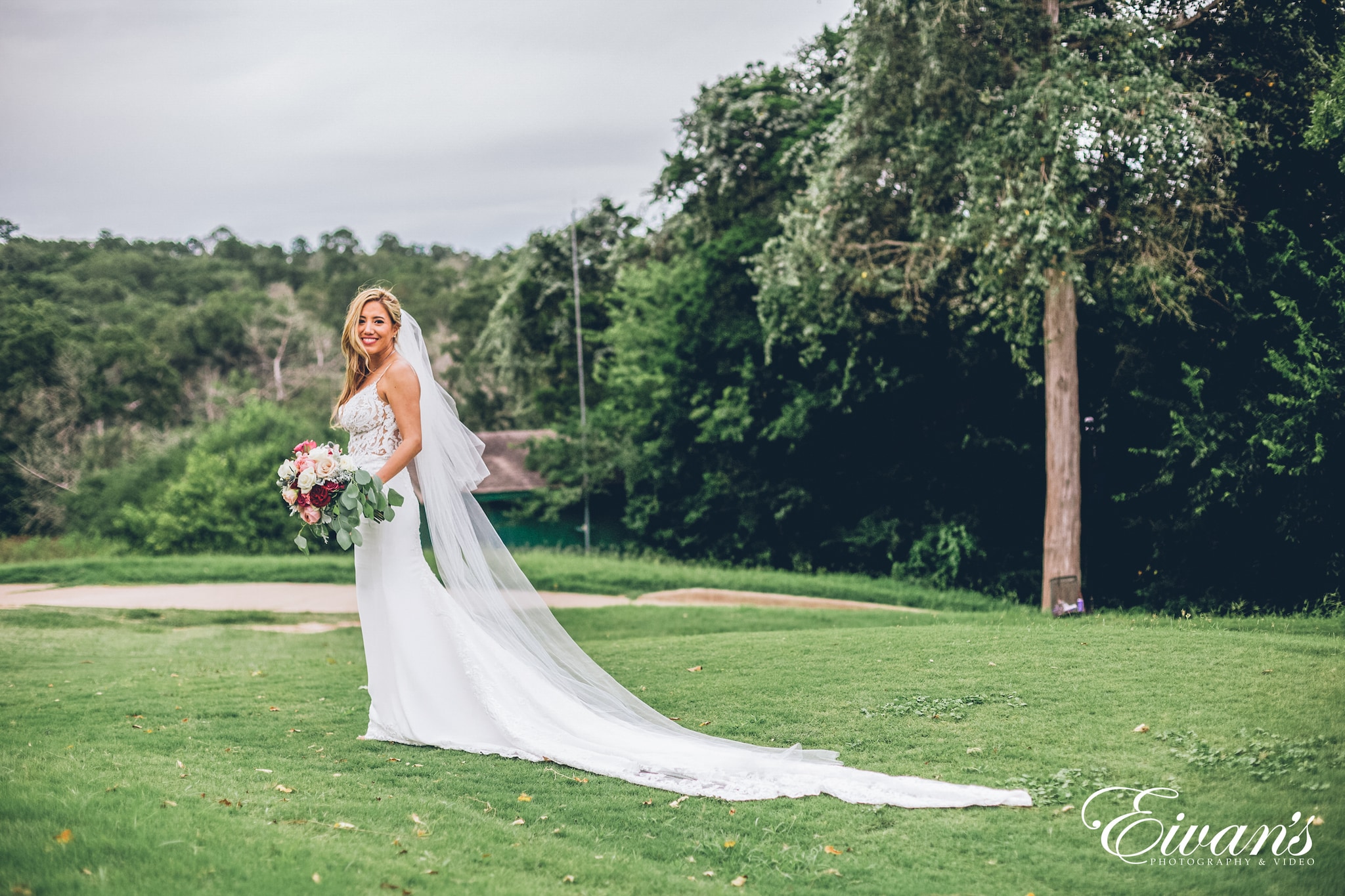 woman in white wedding dress standing on green grass field during daytime