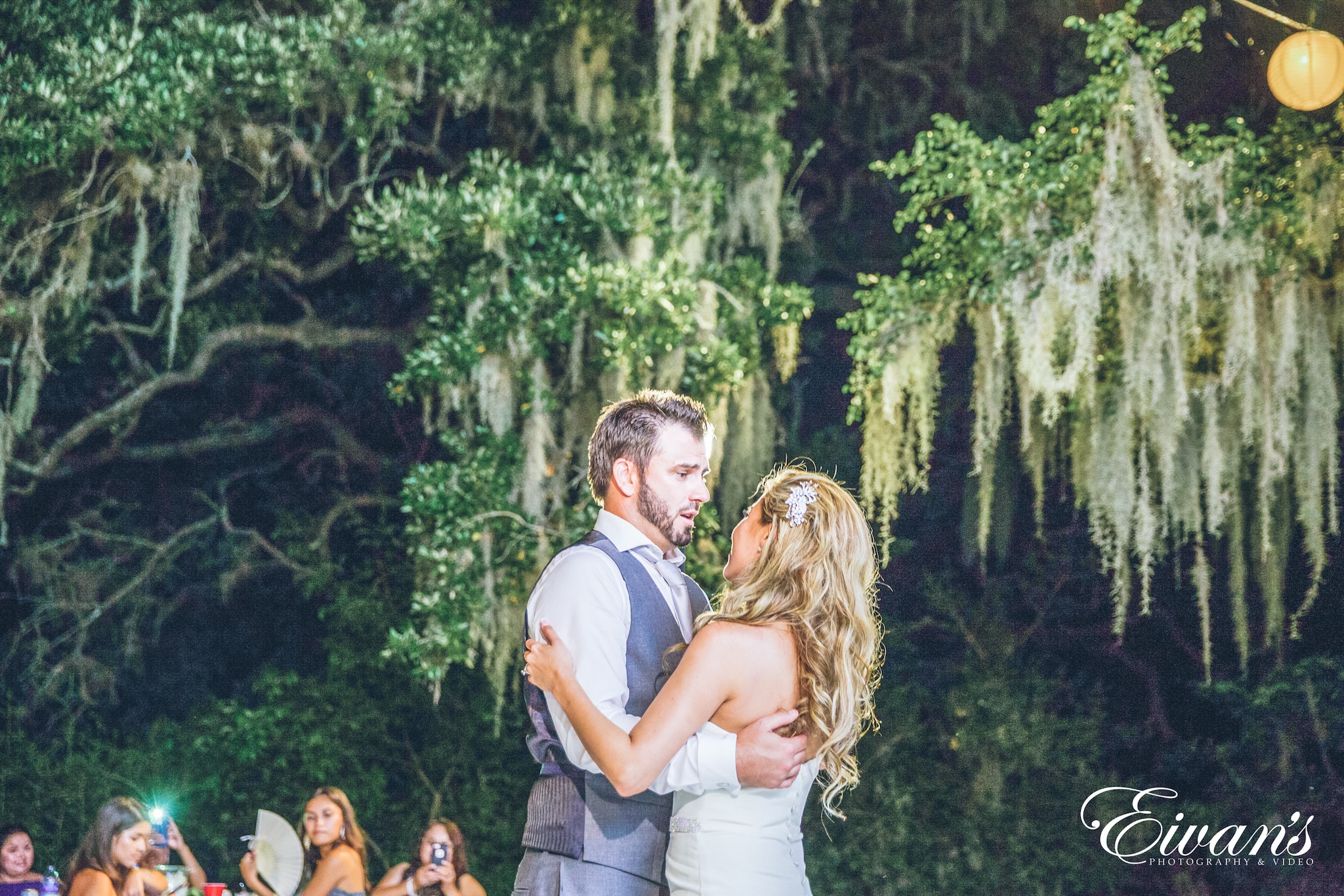 man in white shirt kissing woman in white dress during daytime