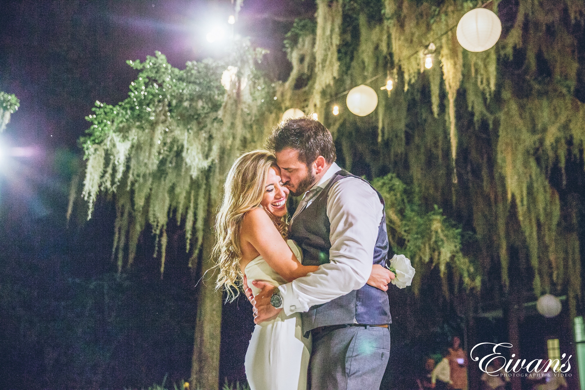 man in gray dress shirt hugging woman in white dress