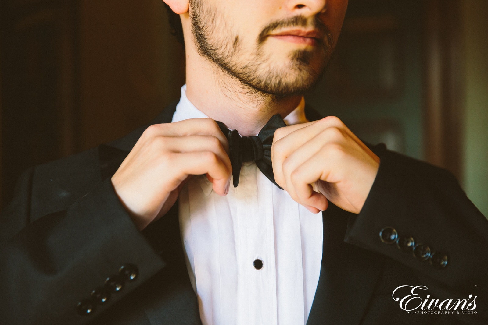 man in black and white polka dot bowtie and white dress shirt