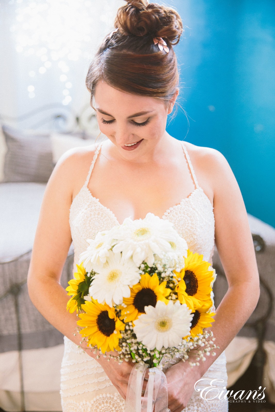 woman in white floral lace tank top holding yellow flower