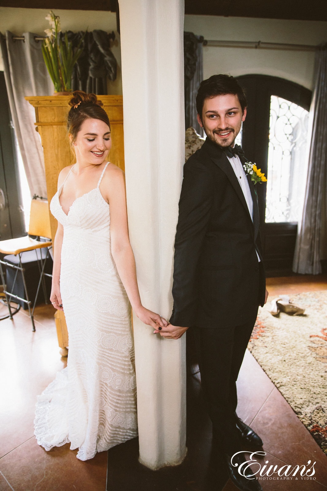 man in black suit standing beside woman in white sleeveless dress