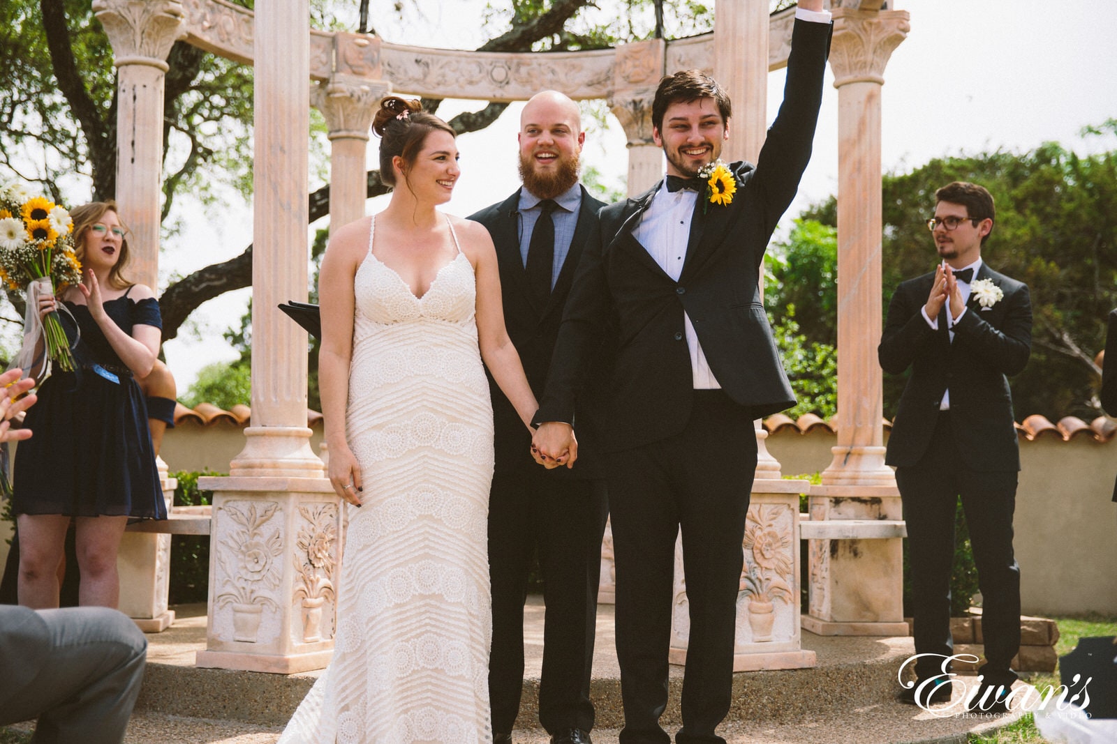 woman in white wedding dress standing beside man in black suit