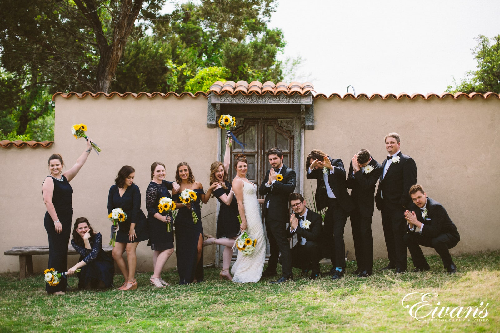 man in black suit standing beside woman in white wedding dress