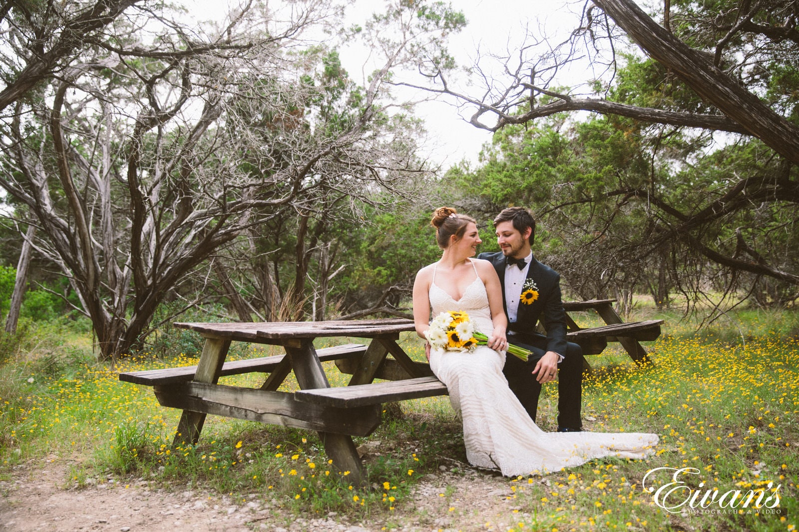 woman in white wedding gown standing beside man in black suit