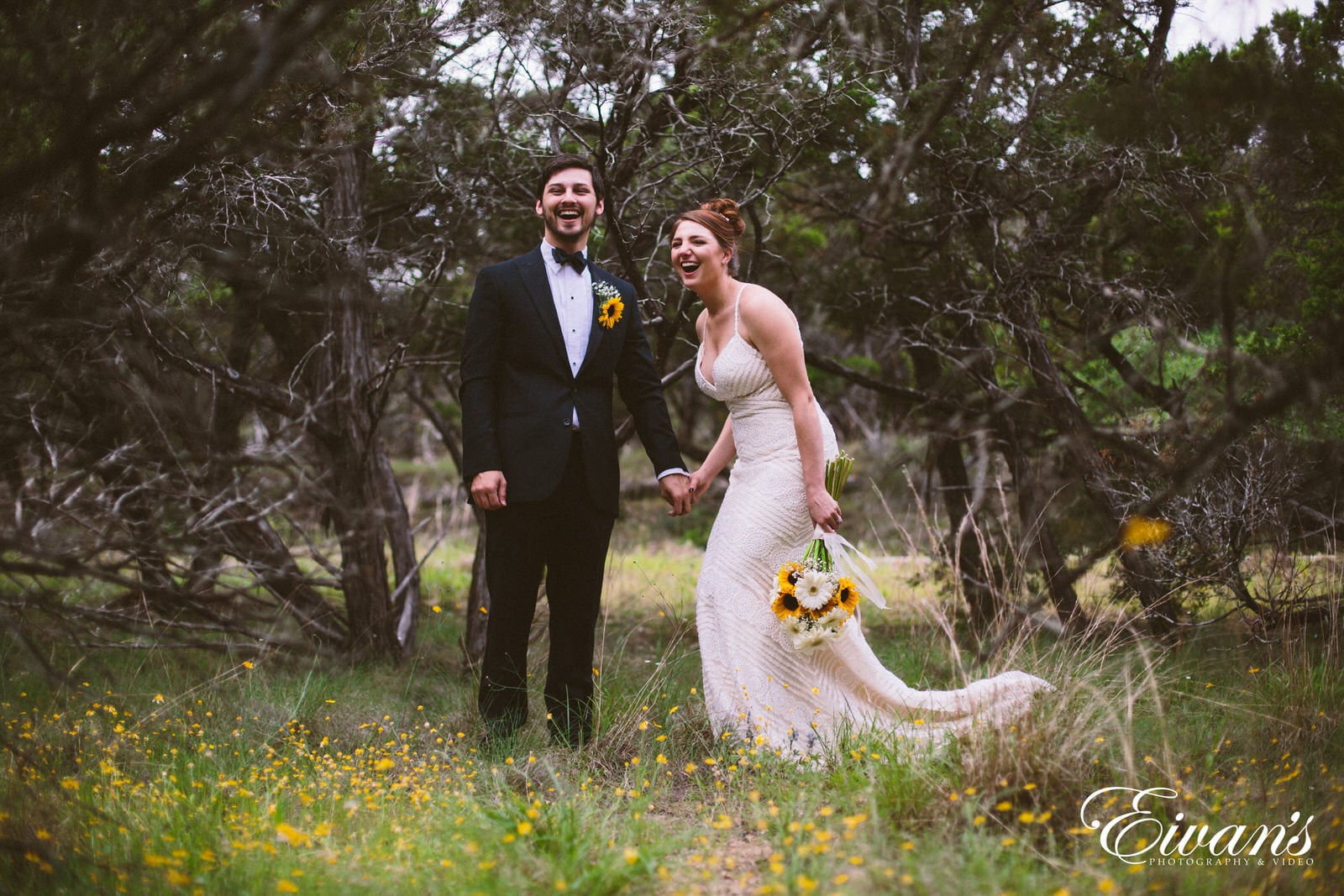 man in black suit standing beside woman in white dress on green grass field during daytime