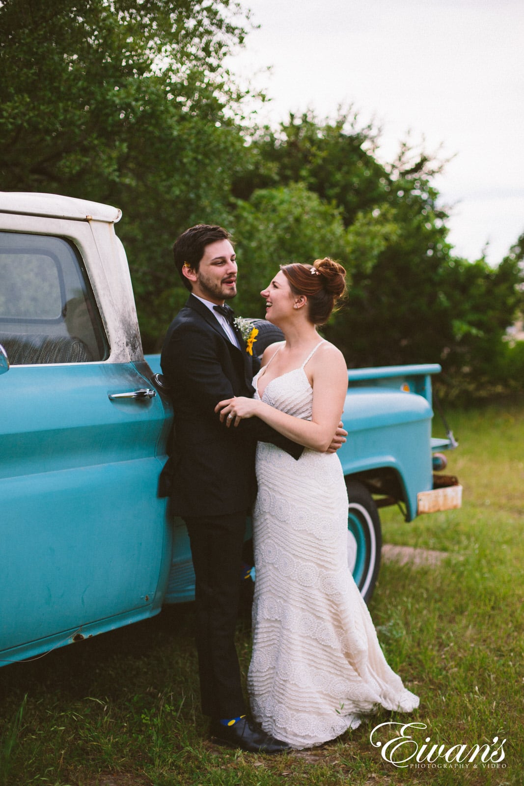 woman in white dress leaning on blue car