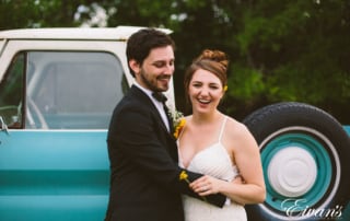 man in black suit jacket and woman in white wedding dress