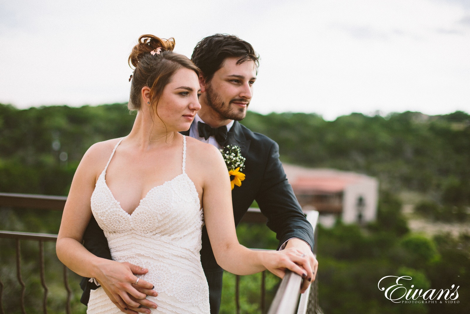 man in black suit kissing woman in white dress