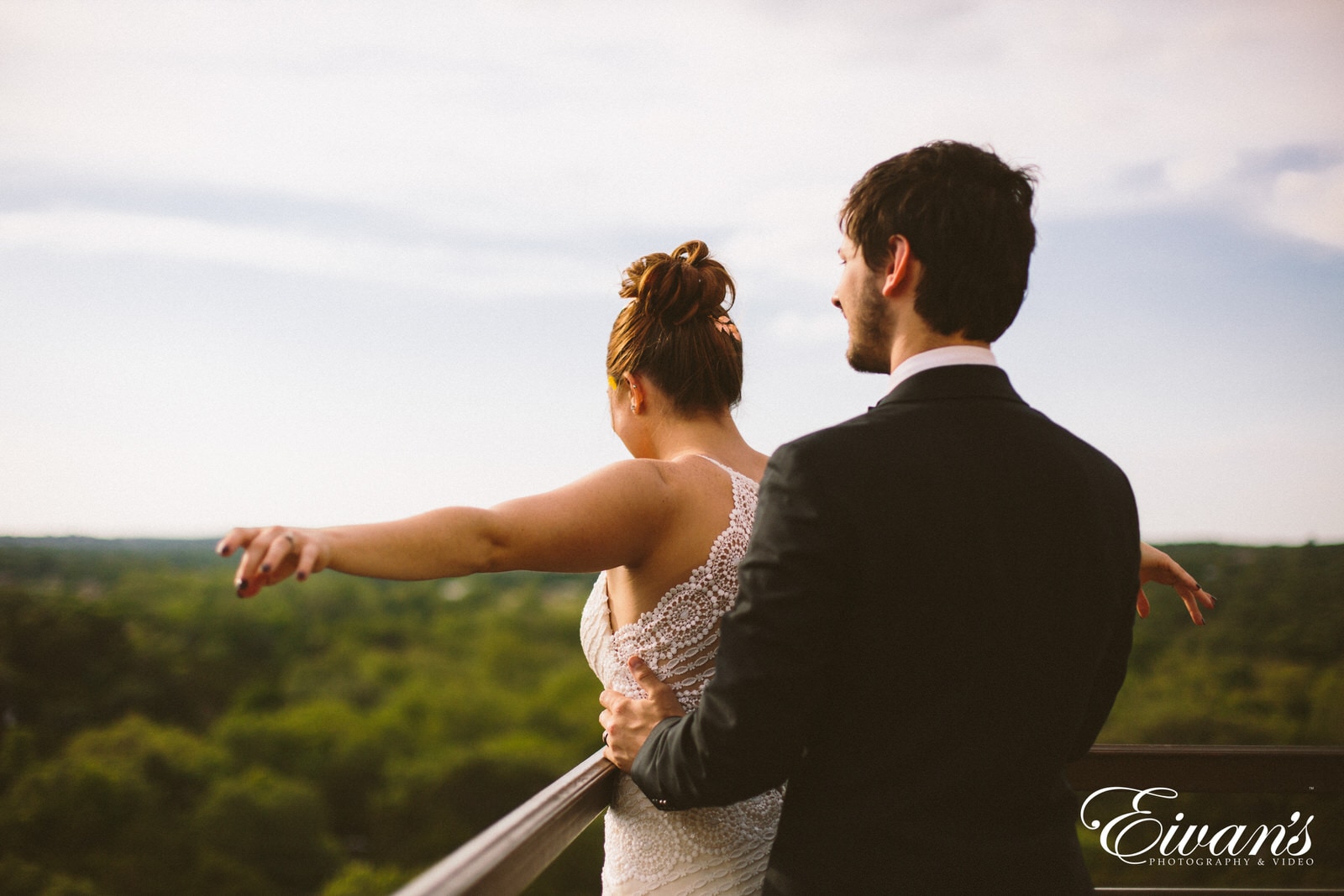 man in black suit jacket kissing woman in white wedding dress