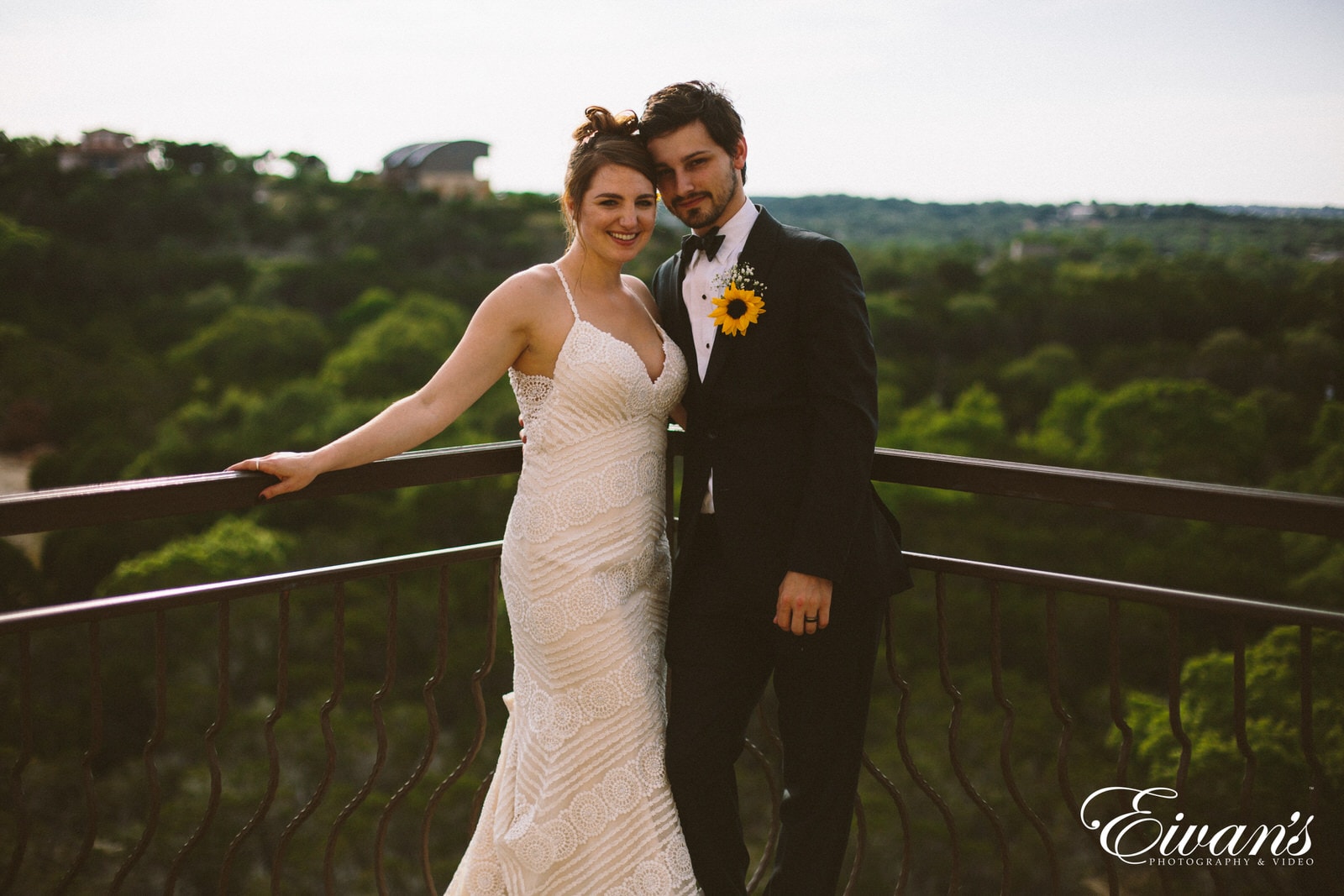 man in black suit and woman in white wedding dress holding on railings during daytime