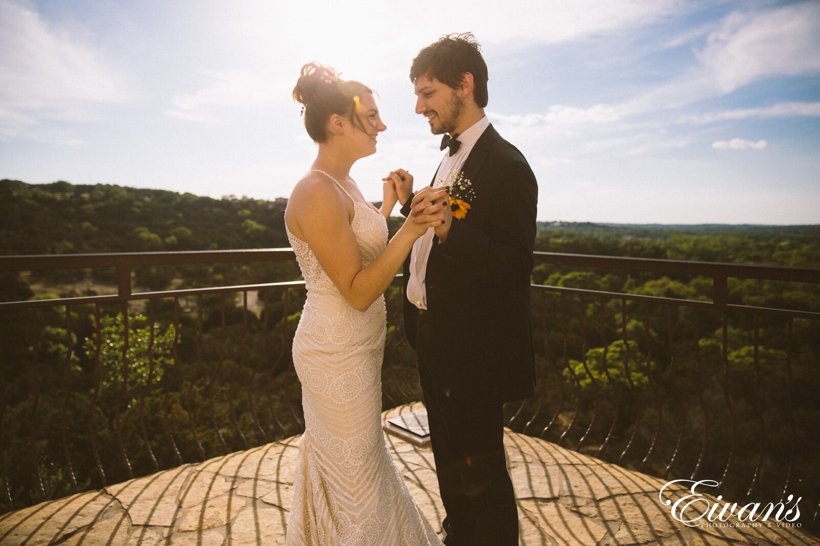 man in black suit kissing woman in white tube dress