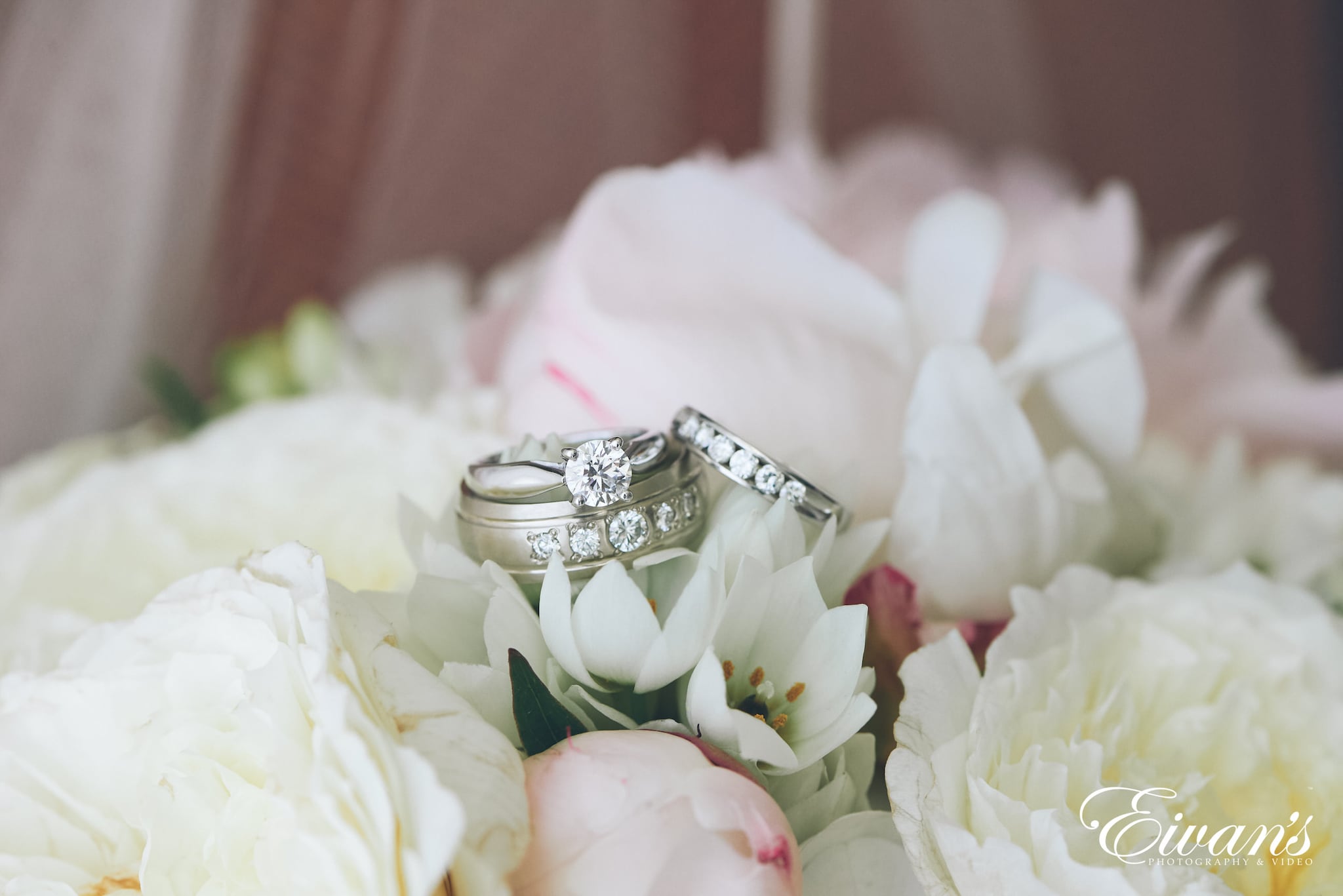 silver diamond ring on white flower petals