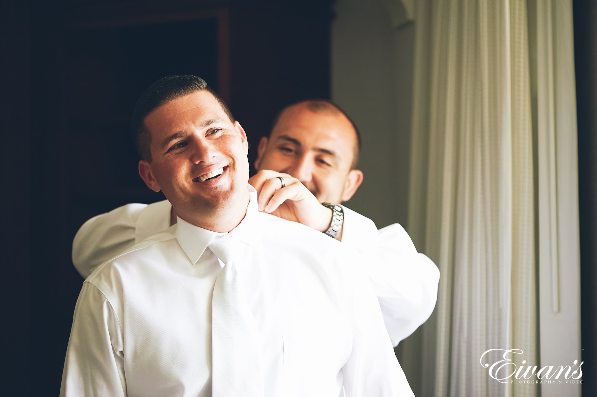 man in white dress shirt carrying baby