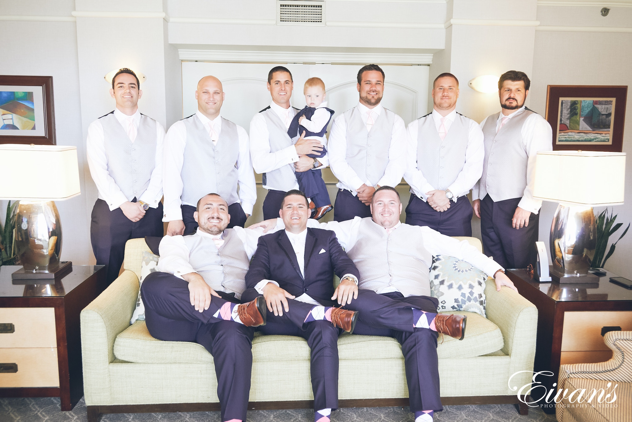 group of men in white dress shirt sitting on gray couch