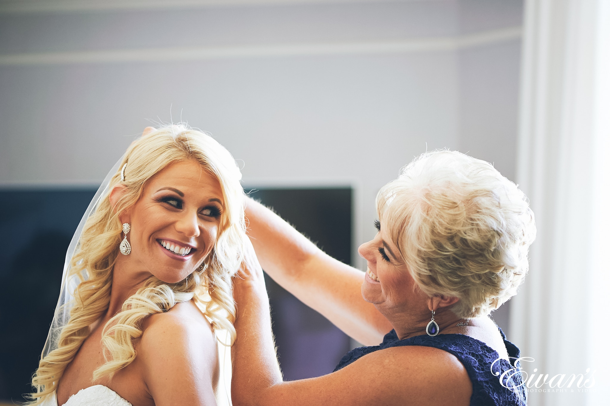 woman in black tank top smiling beside woman in blue tank top