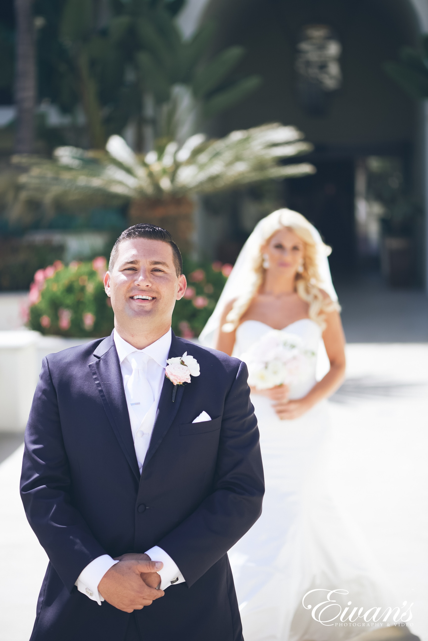 man in black suit and woman in white wedding dress