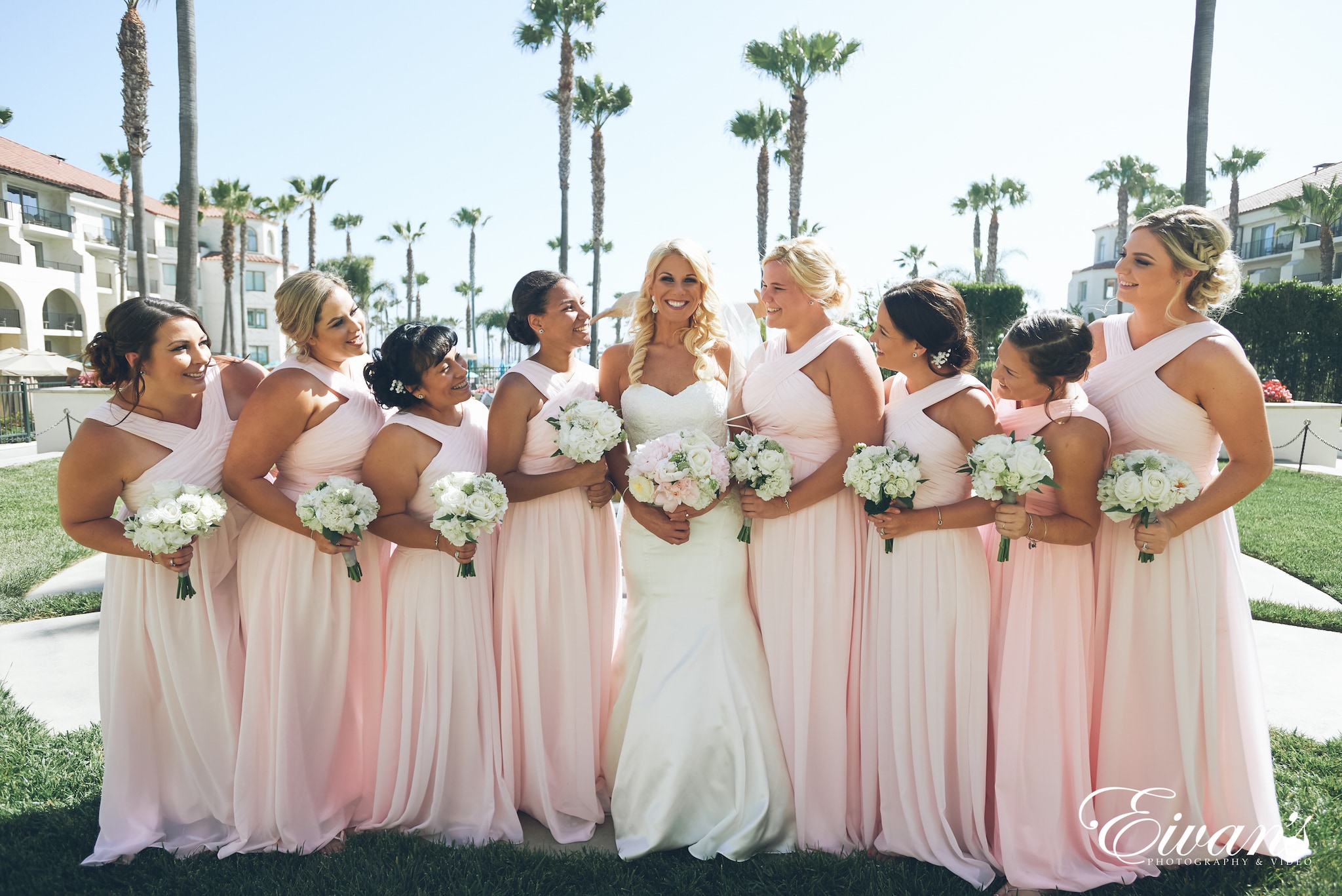 group of women in white and pink dresses