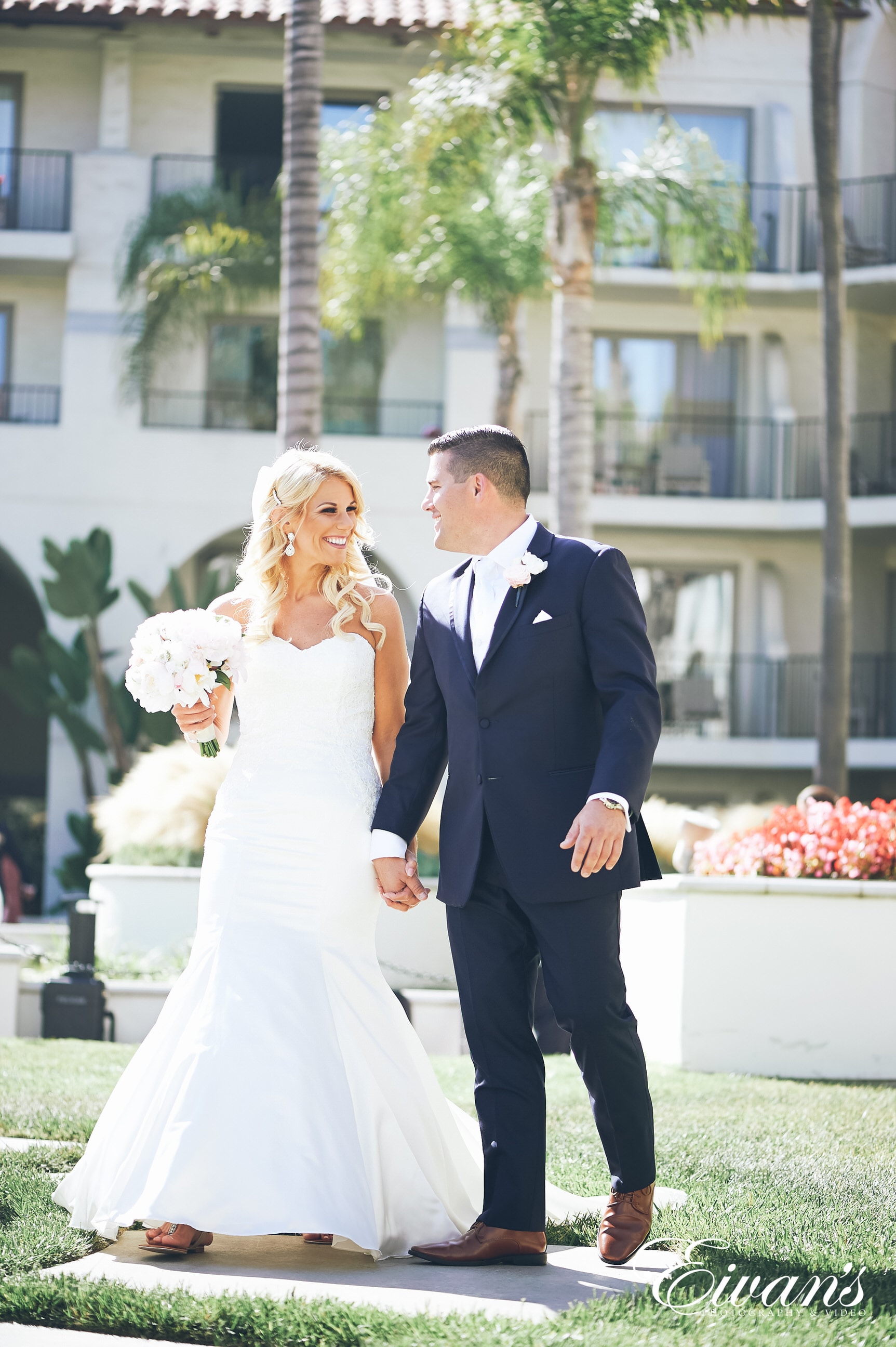 man in black suit jacket holding woman in white wedding dress