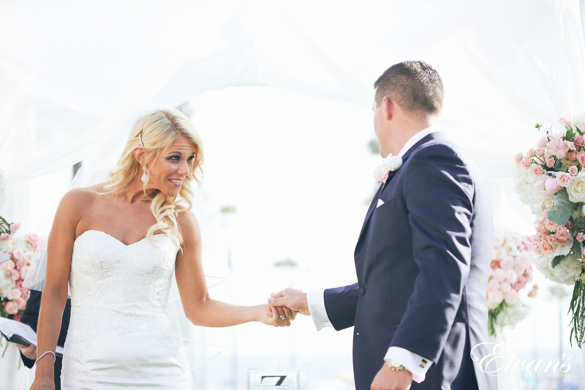 man and woman holding hands at the alter