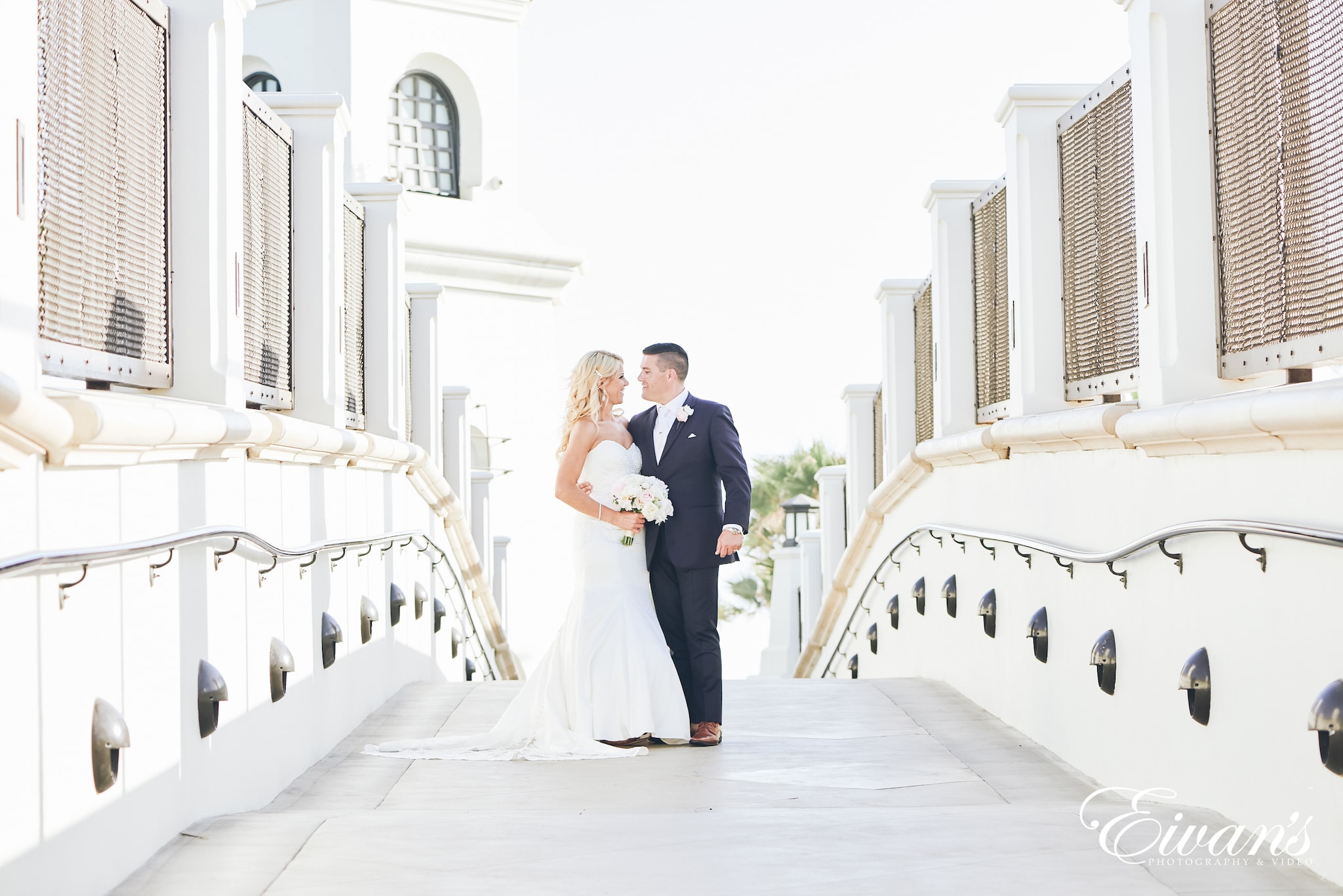 man and woman posed on a bridge