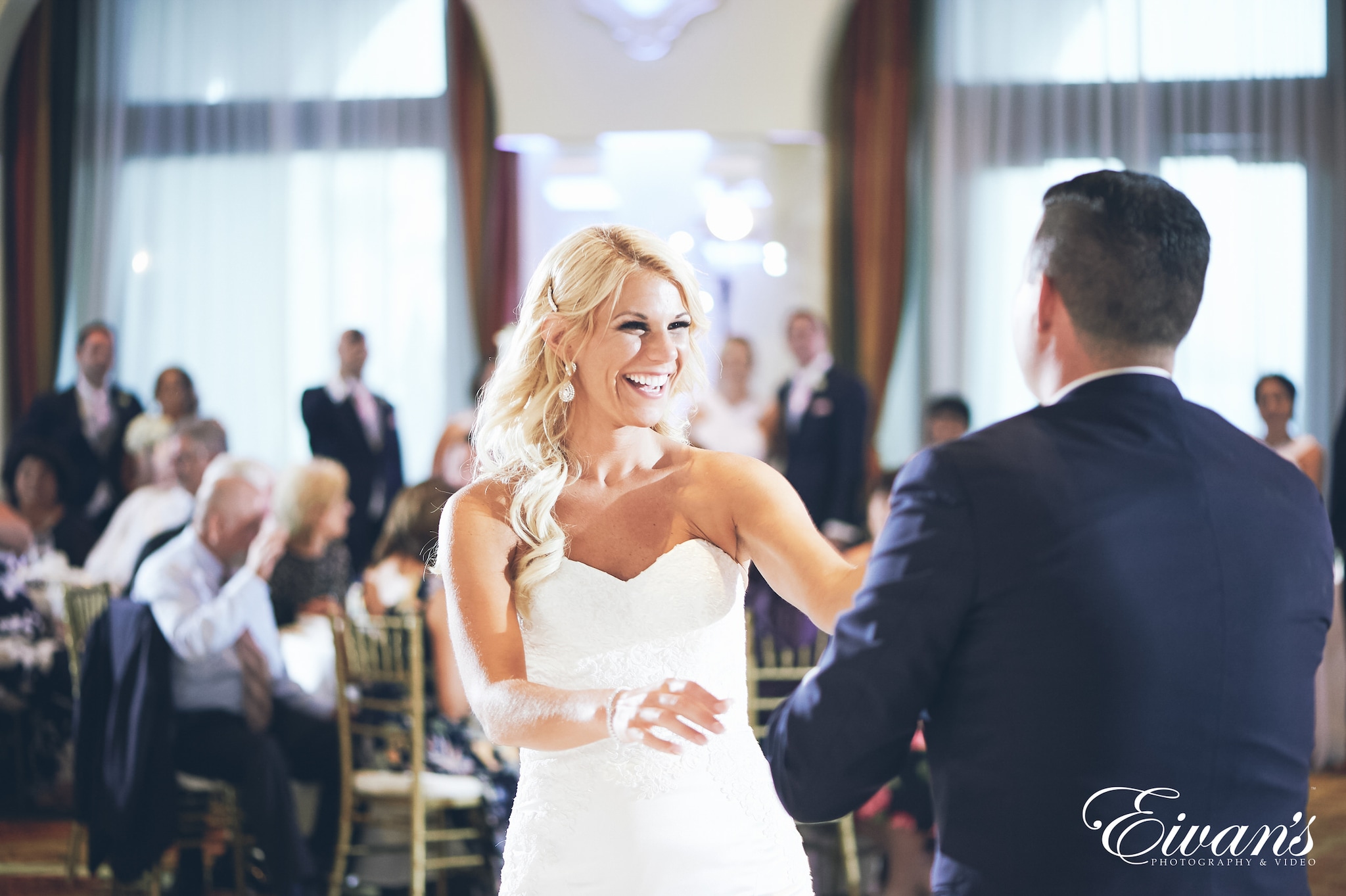 woman in a white dress laughing