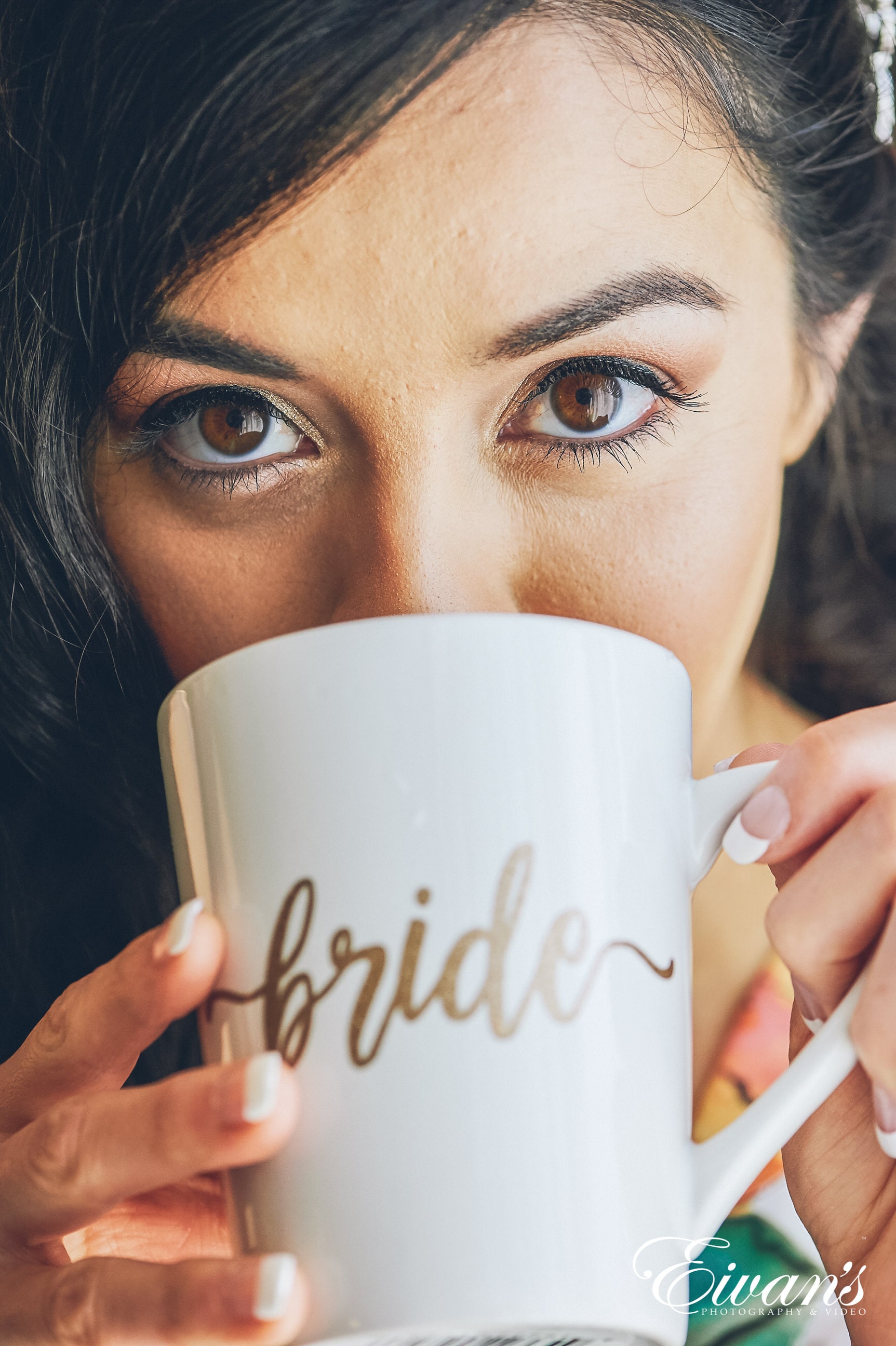 close up shot of woman with brown eyes drink out of a mug