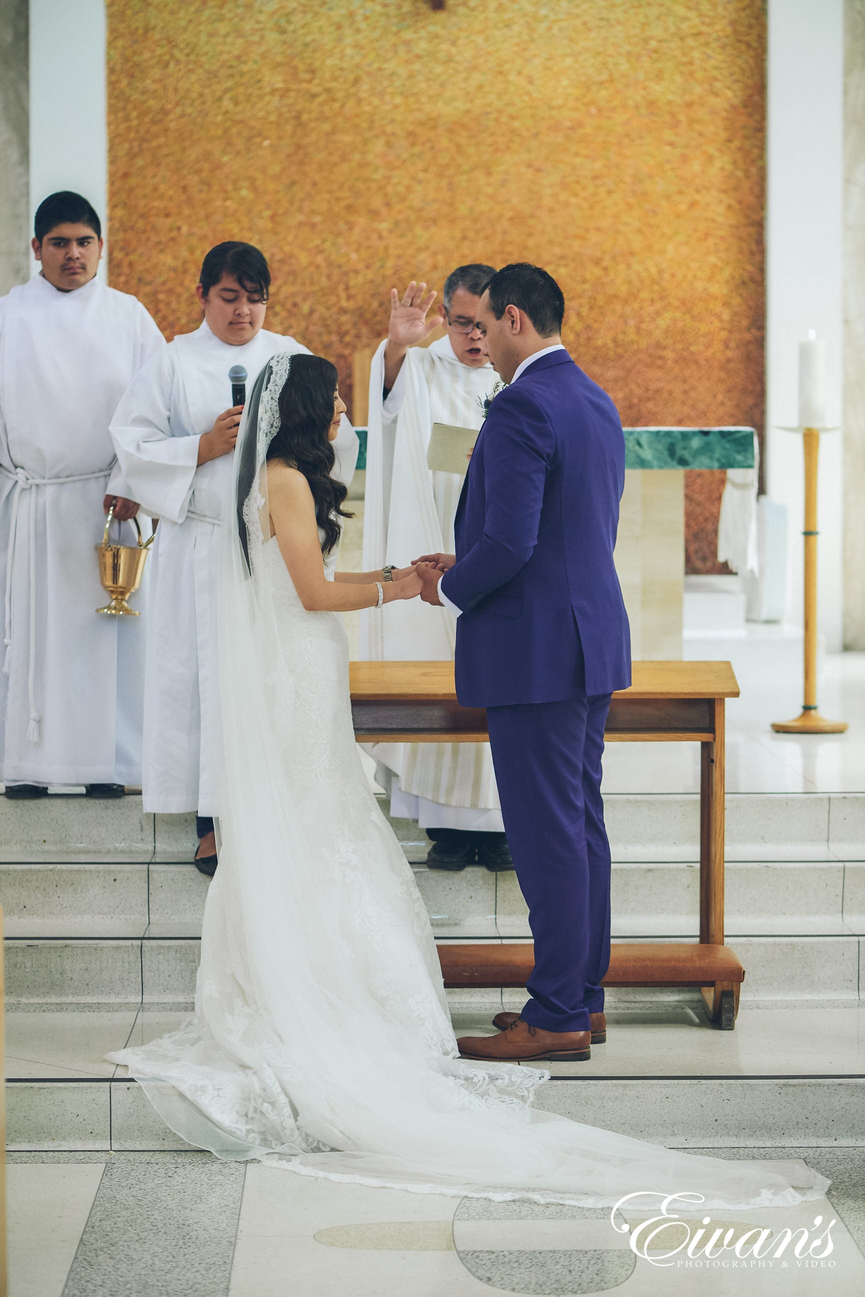 man and woman in a white dress holding hands