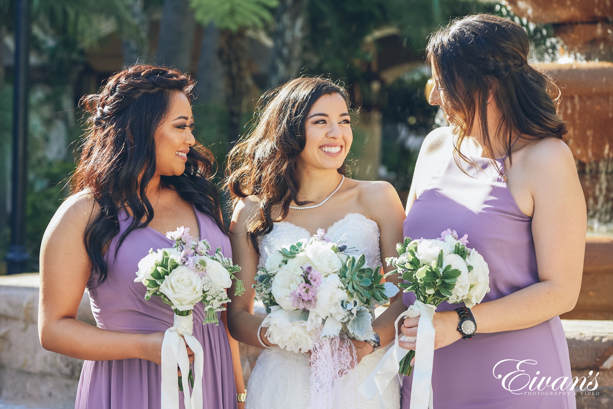 three woman holding bouquets