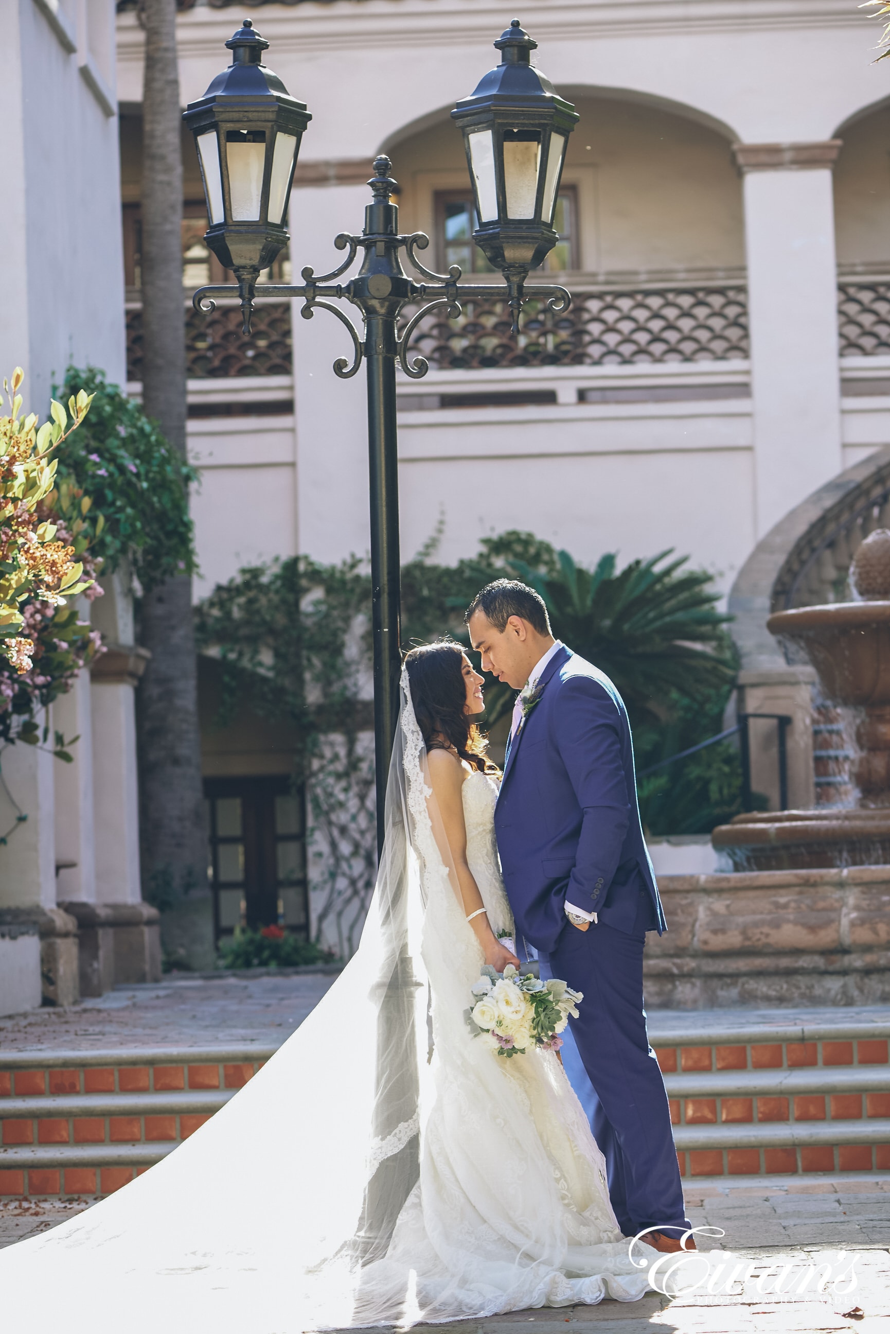 woman and man posed against a light pole in the daytime