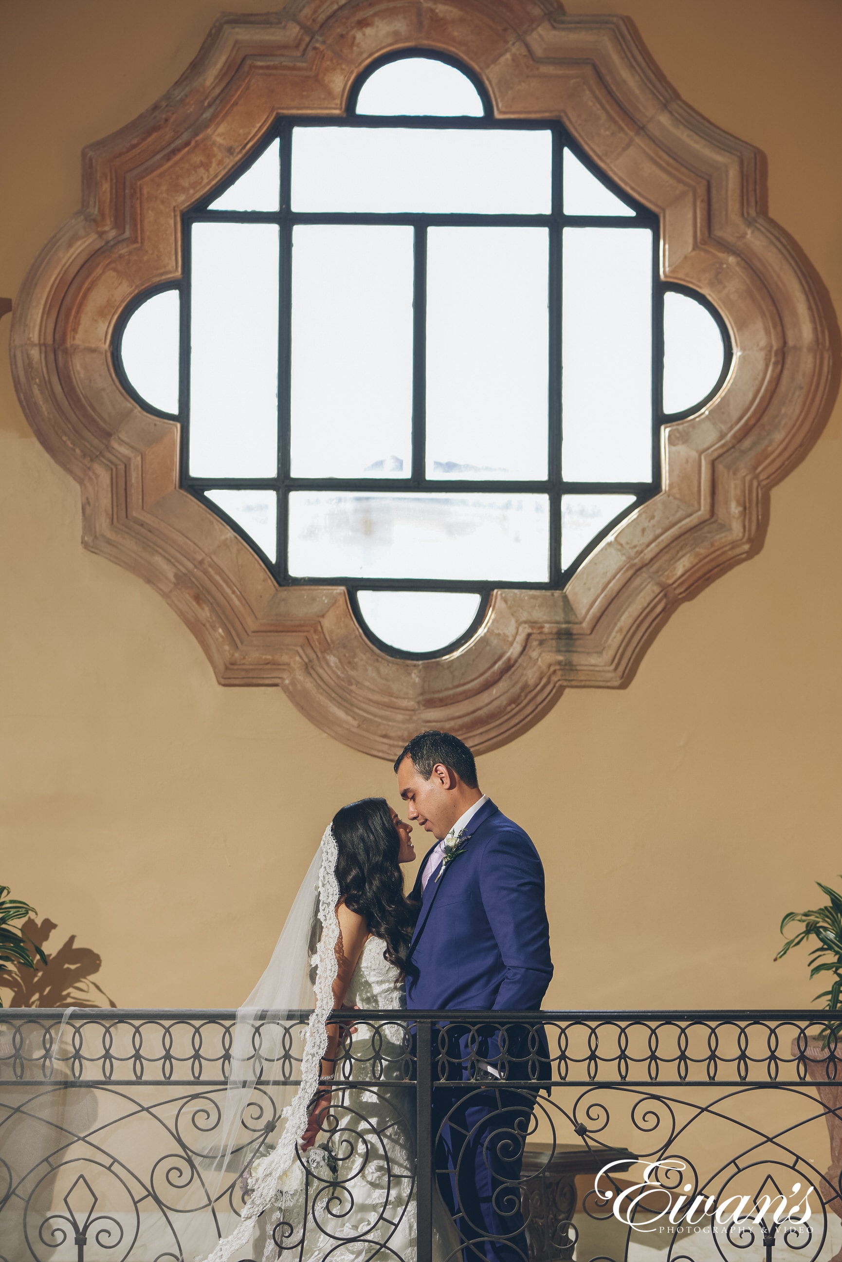 man and woman posed in front of a window