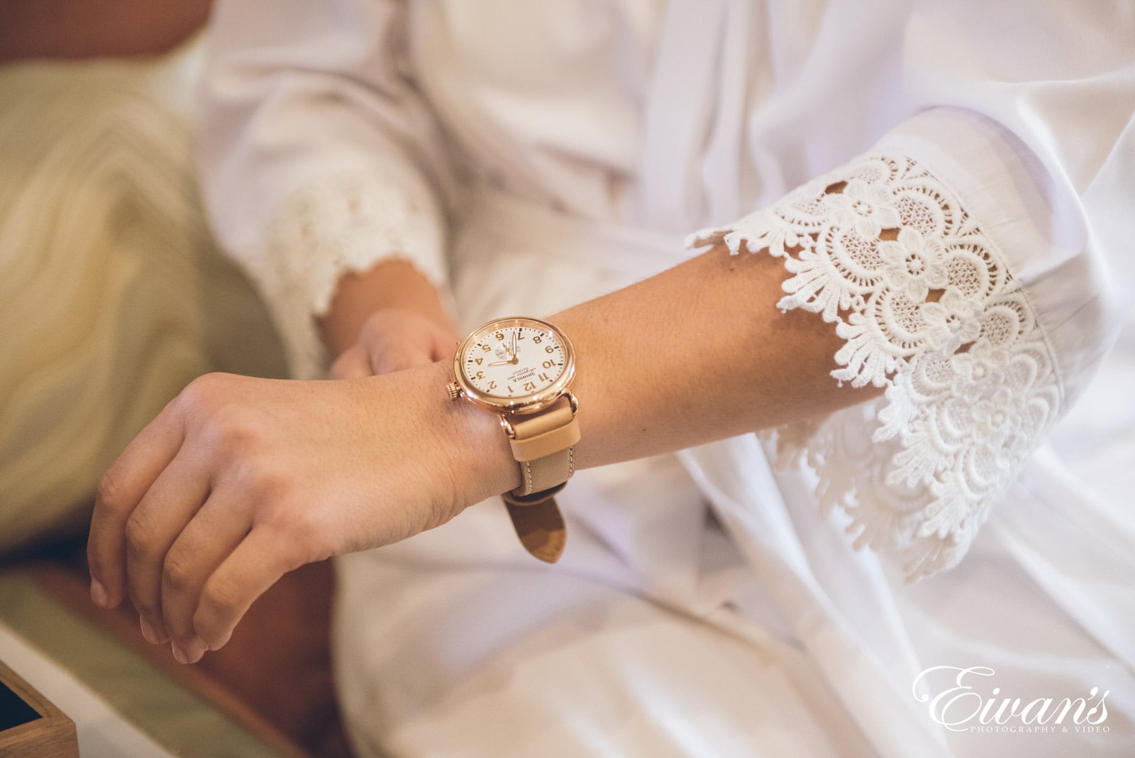 woman in a white robe wearing a gold watch