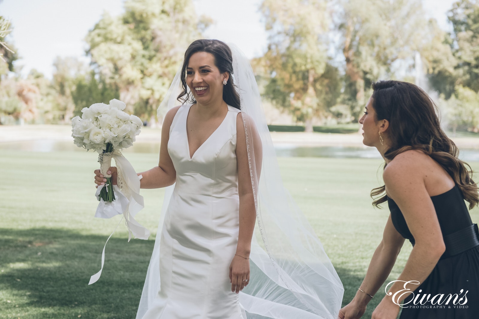 woman in a white dress holding a bouquet of flowers outside in the daytime